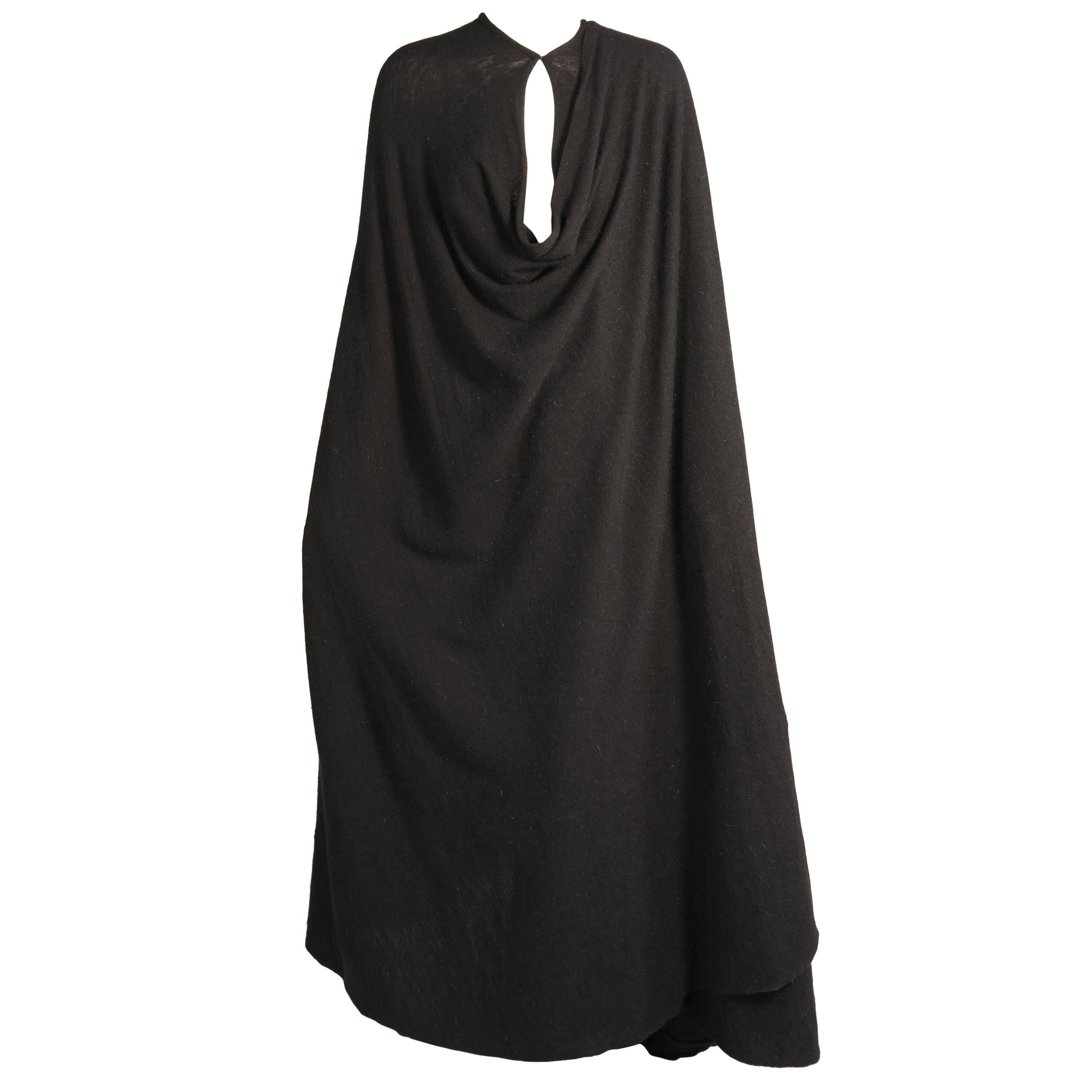 Madame Gres is famous for her draping and this fluid black angora and wool blend evening cape is a spectacular example of her work. The cape is made from a luxuriously soft fabric and it has a single hook and fabric eye closure and only three seams.