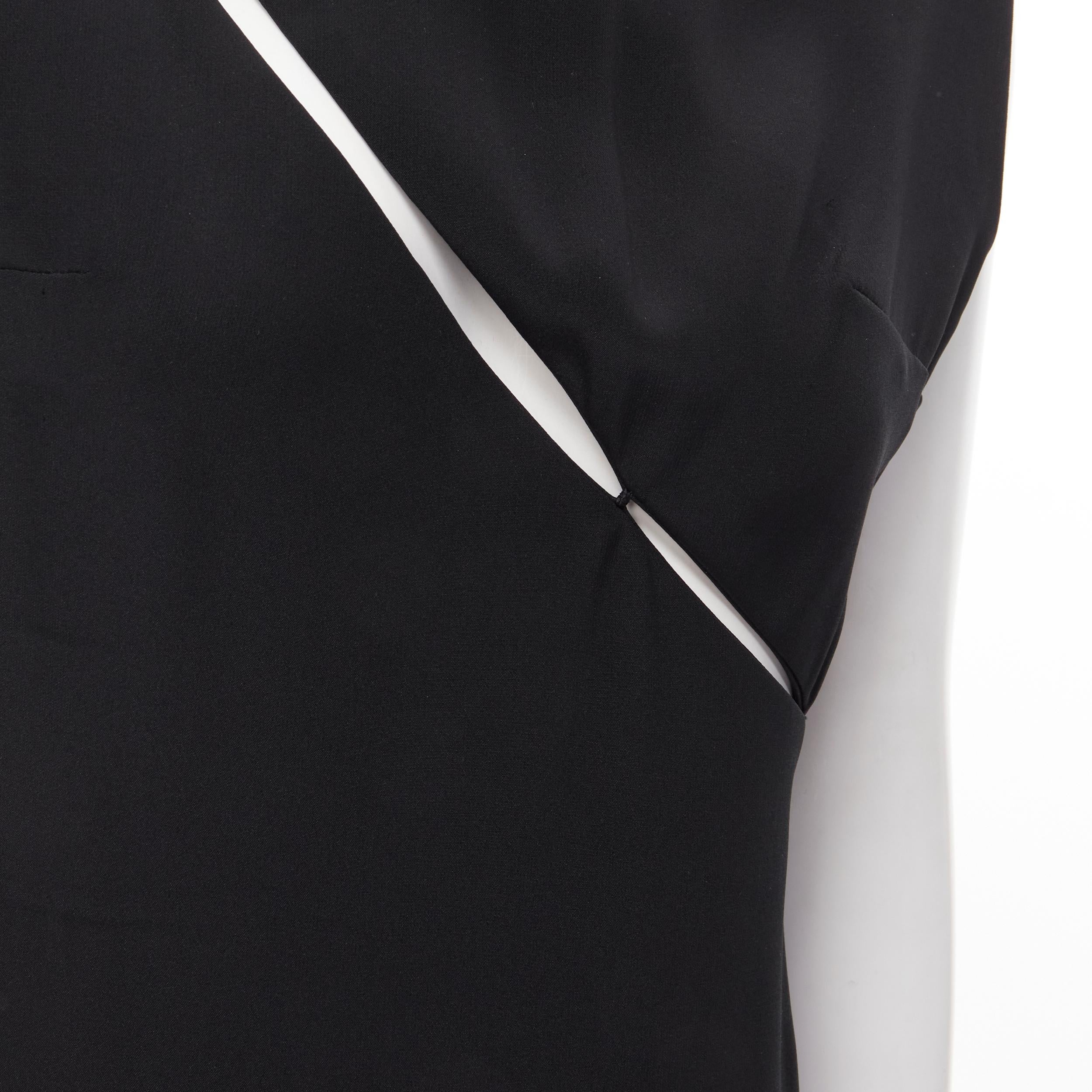 MADAME GRES Haute Couture Paris 1972 black crepe slash slit cut out dress M 
Reference: CRTI/A00404 
Brand: Gres 
Designer: Madame Gres 
Color: Black 
Pattern: Solid 
Closure: Zip 
Extra Detail: Snap buttons at shoulder.Side zip closure. Slashed cut