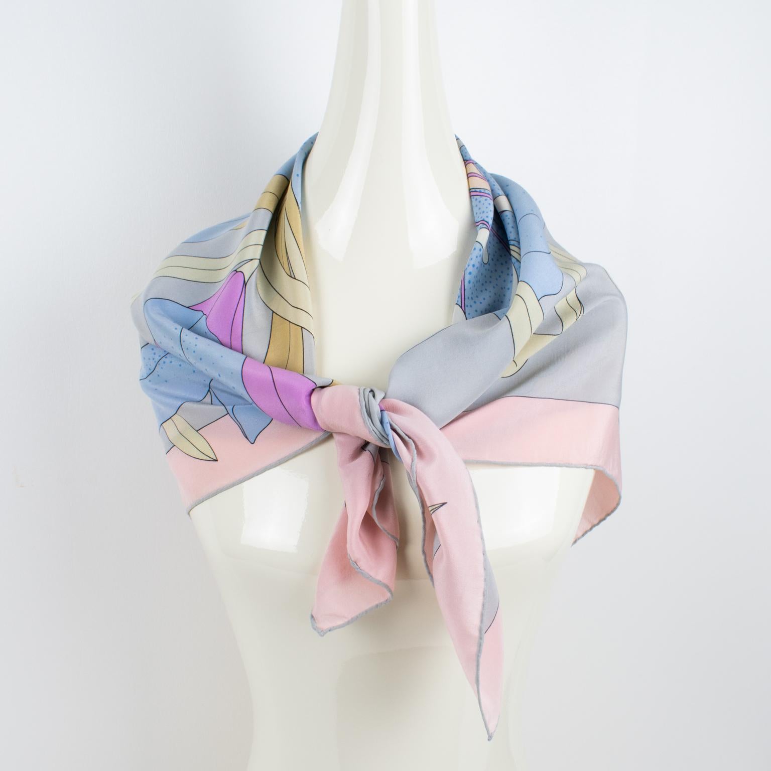 This lovely Madame Grès Paris silk scarf features a lush design of a giant flower in pastel tones. This fashion accessory has the Grès Paris logo, on the bottom right corner. The combination of baby blue, fuchsia pink, yellow mustard, and sand beige