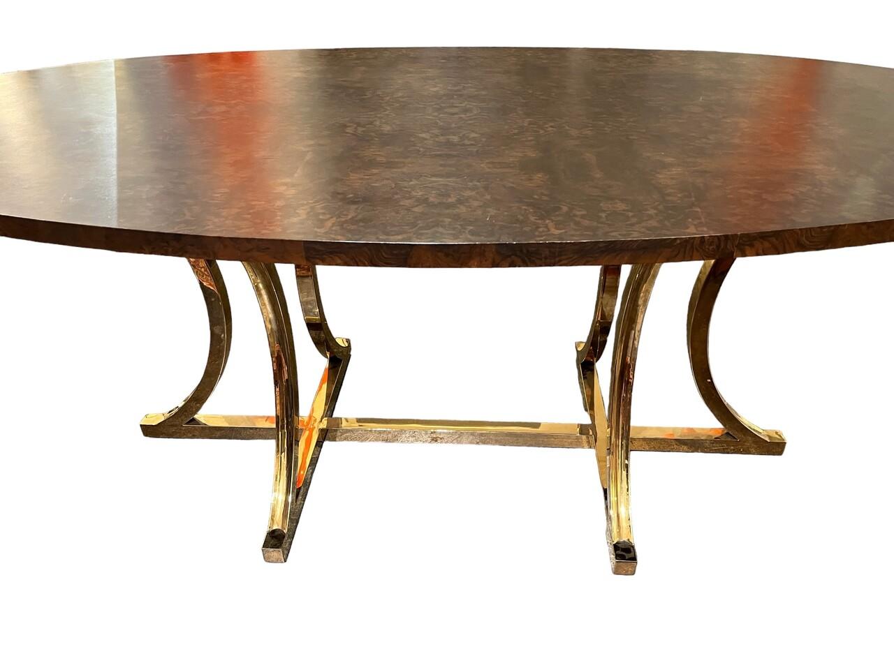 Beautiful Oval Dining table with burl walnut veneer top and a polished brass base.