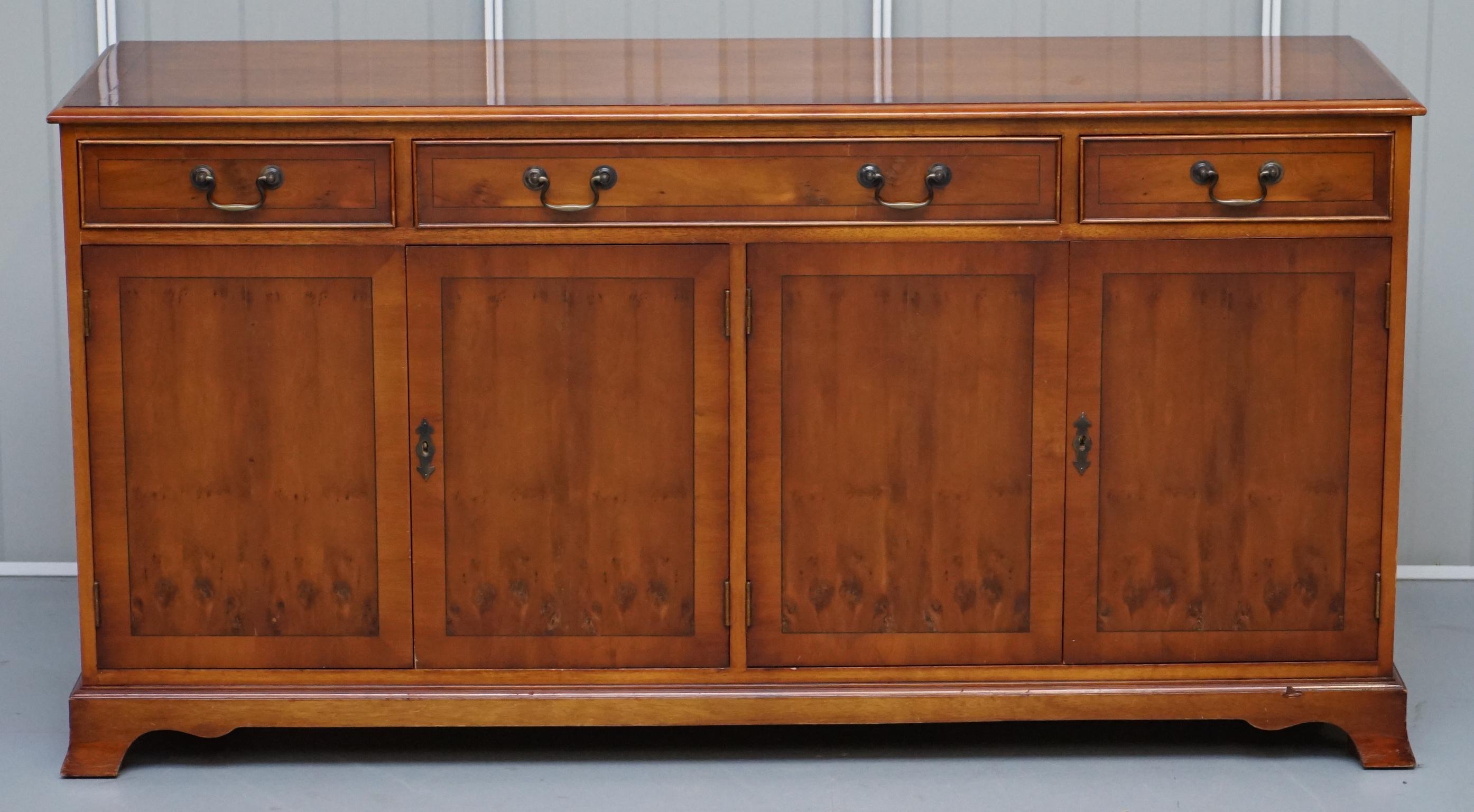 We are delighted to offer for sale this very well made Burr Yew wood three drawer two cupboard sideboard hand made in England by Bradley Furniture 

A very good looking and well made piece, it has two large cupboards to the base, one with a shelf