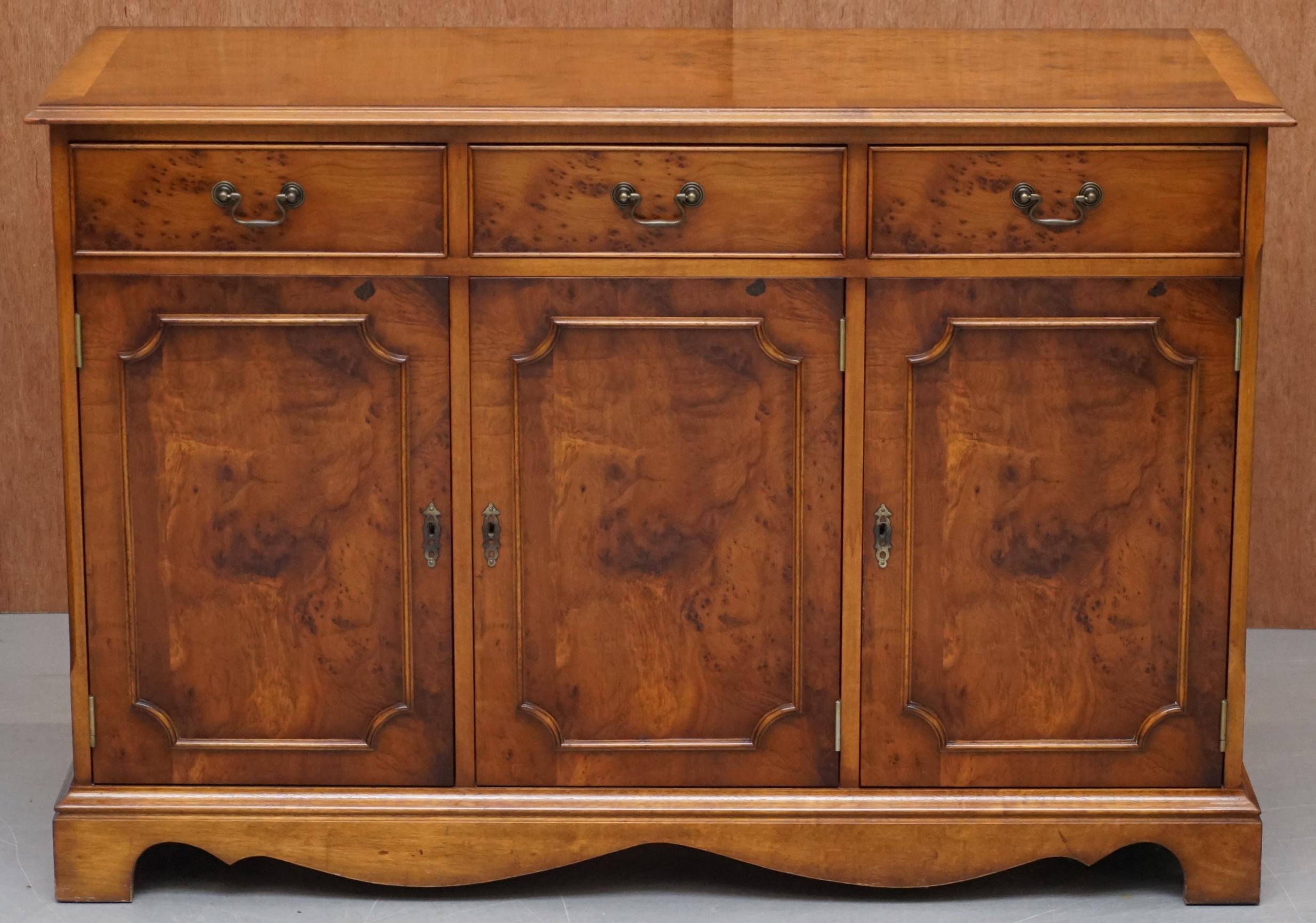 We are delighted to offer for sale this very well made Burr Yew wood three drawer two cupboard sideboard hand made in England by Craft Furniture 

A very good looking and well made piece, it has three medium cupboards to the base, all of which are