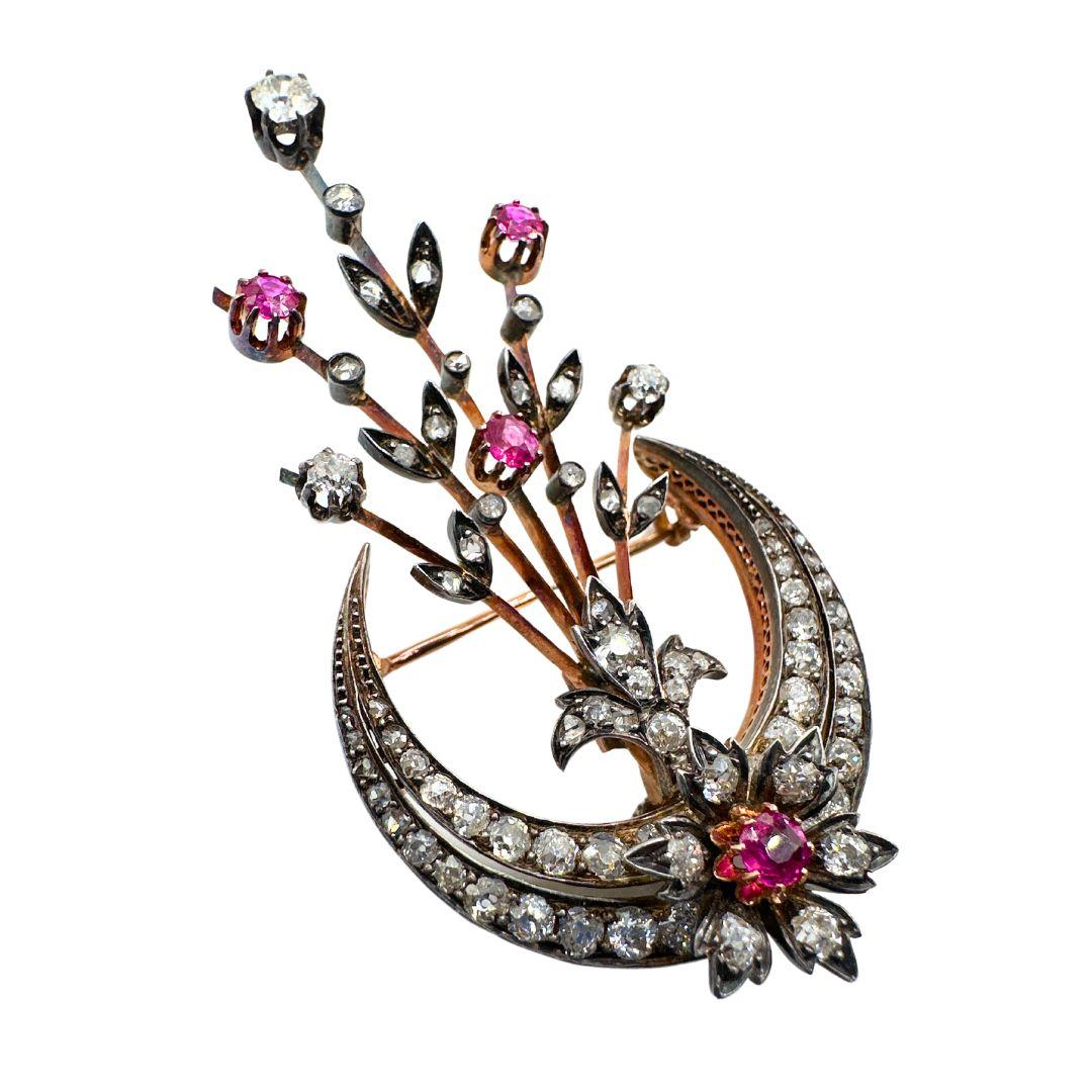 This item is an antique 19th-century diamond crescent moon brooch with a detachable spray of rubies and diamonds. It is made in France, circa 1860. The brooch features an elegant double-row crescent moon design adorned with 40 diamonds, all set in