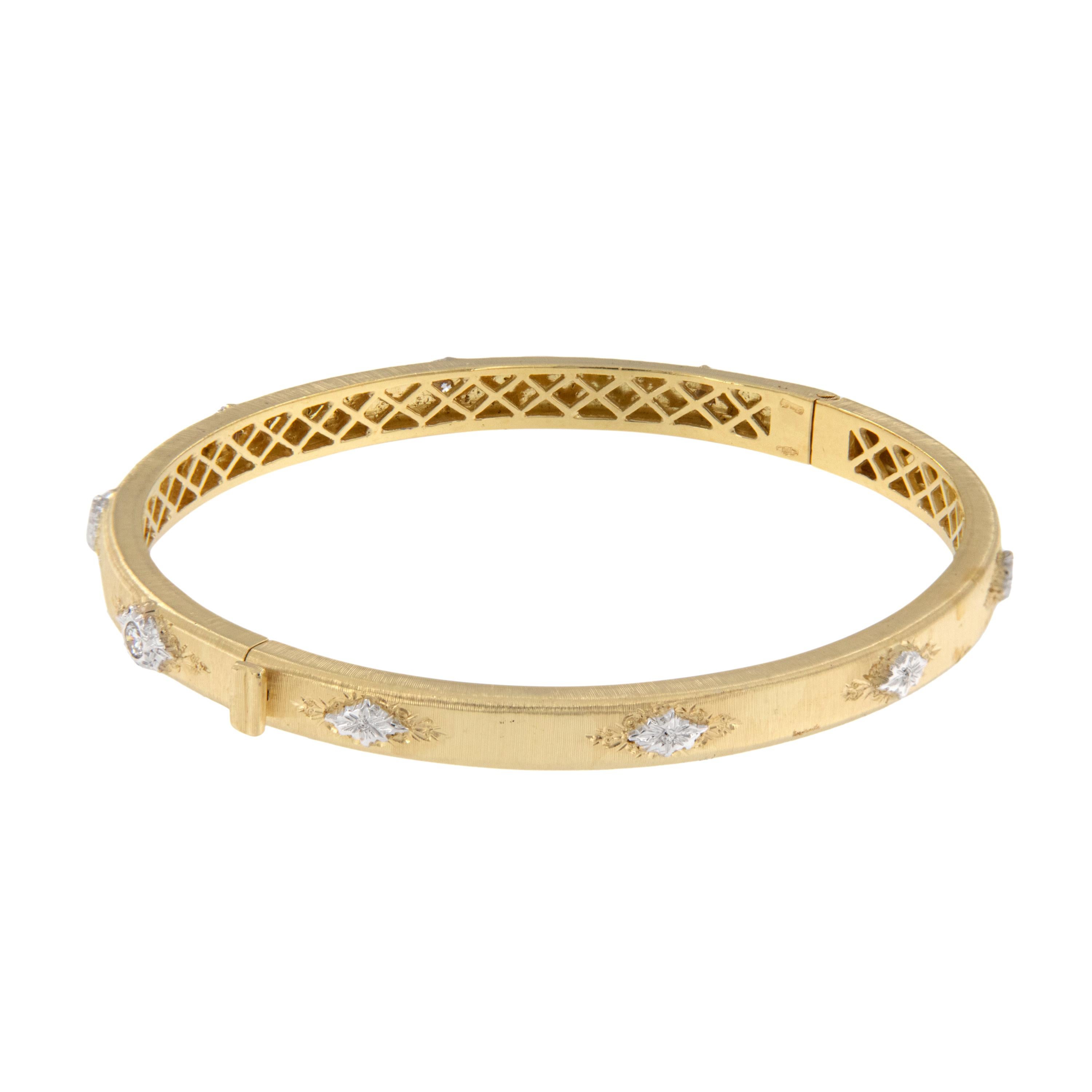 Nobody does it like the Italians! This 18 karat yellow gold bangle bracelet was made in Italy and is accented with 6 RBC diamonds = 0.35 Cttw in white gold bezels further detailed with signature Florentine finish. 7 3/16