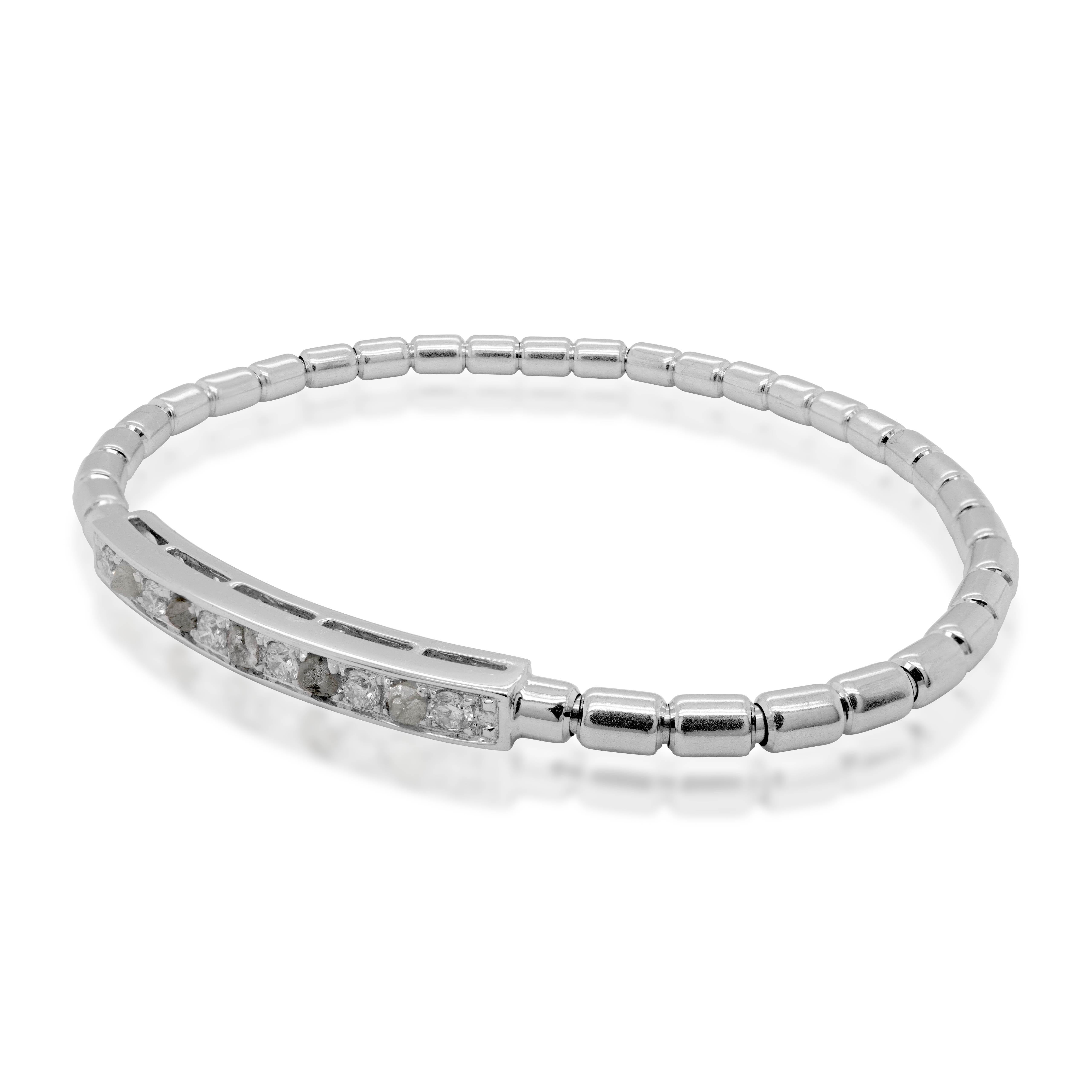 Using ground Breaking innovation, this 18K white gold bracelet uses Japanese technology for bracelet. Using white round diamond and steel gray raw diamonds, the 18K bracelet is a cool chic wear