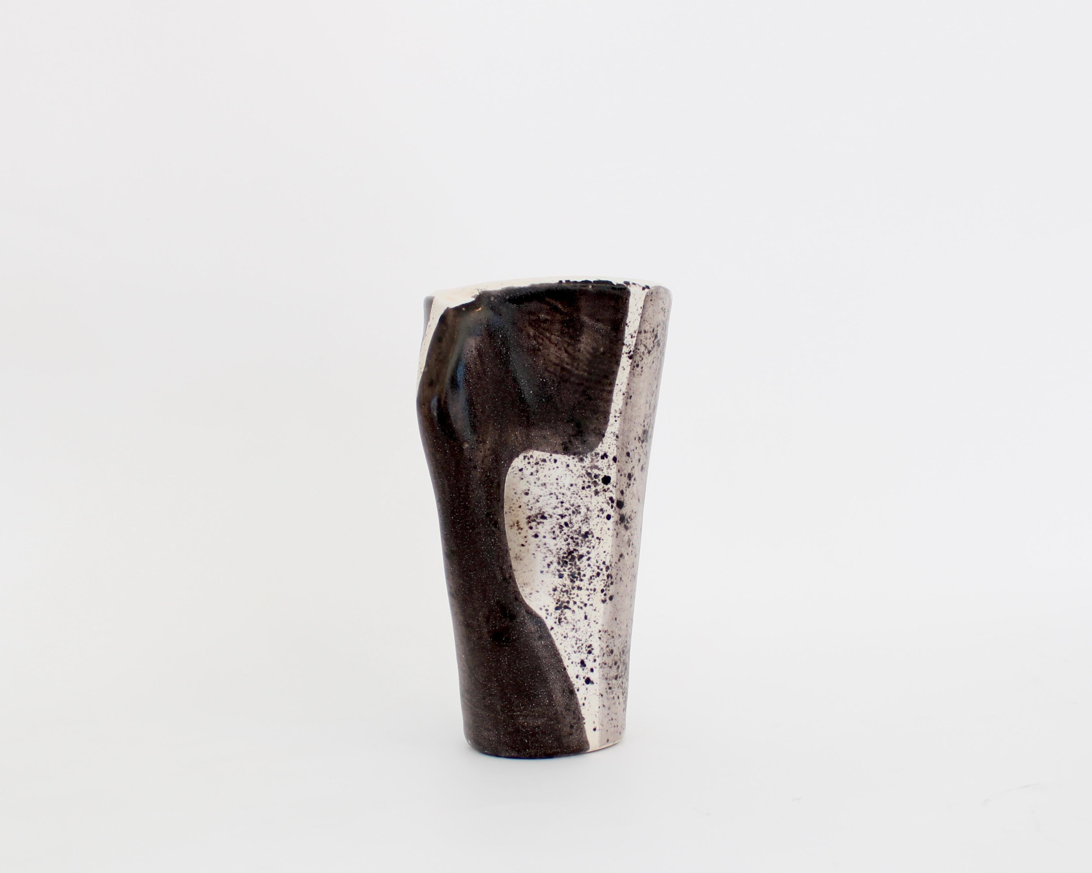 Mado Jolain 1921-2019 ceramic vase with black, white and grey abstract drawings on each surface with very pale undertones of mauve and pink and a glazed interior. With handle. Signed MJ. 
Iconic abstract drawings and forms of the French ceramic