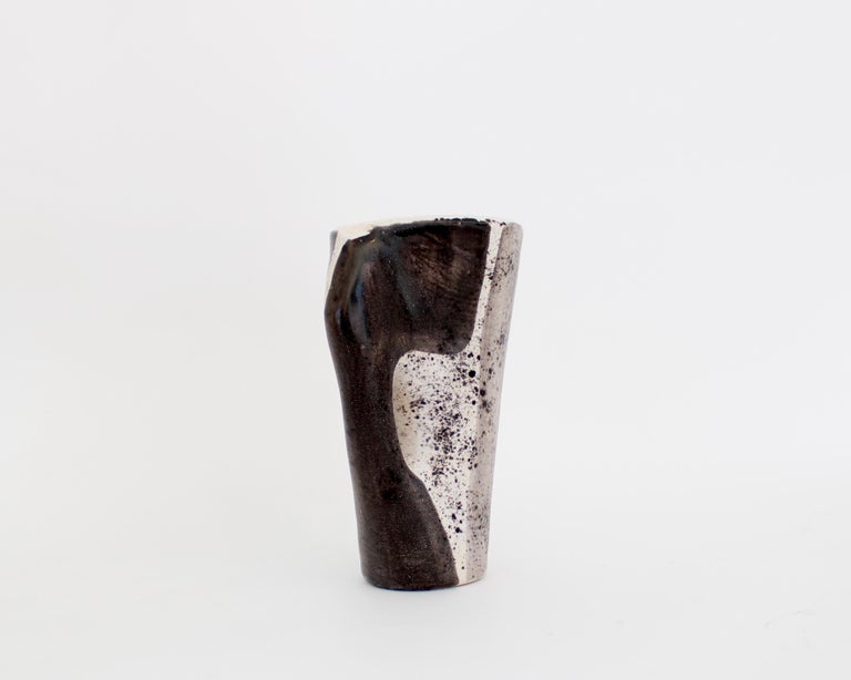 Mado Jolain 1921-2019 ceramic vase with black, white and grey abstract drawings on each surface with very pale undertones of mauve and pink and a glazed interior. With handle. Signed MJ. 
Iconic abstract drawings and forms of the French ceramic