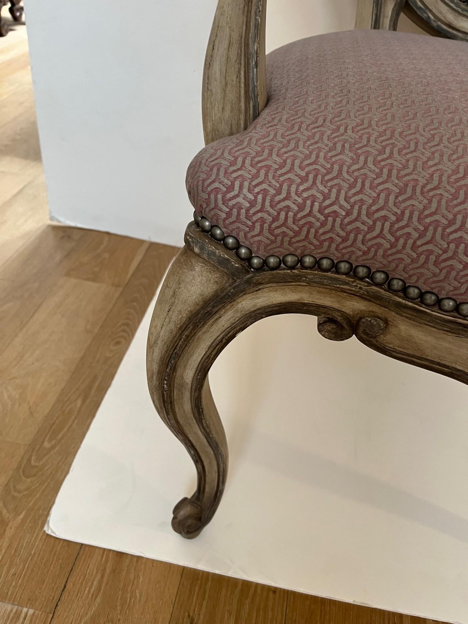 Made to order Louis XV Style Dining Armchair Upholstered in Fortuny Fabrics with Antique Brass Nail Heads Trim at Seat and Inside Oval Back and Arm Rest, Finished in Antiqued Painted Finish, Chair Frame is Solid Wood.
Upholstery: Customer Own