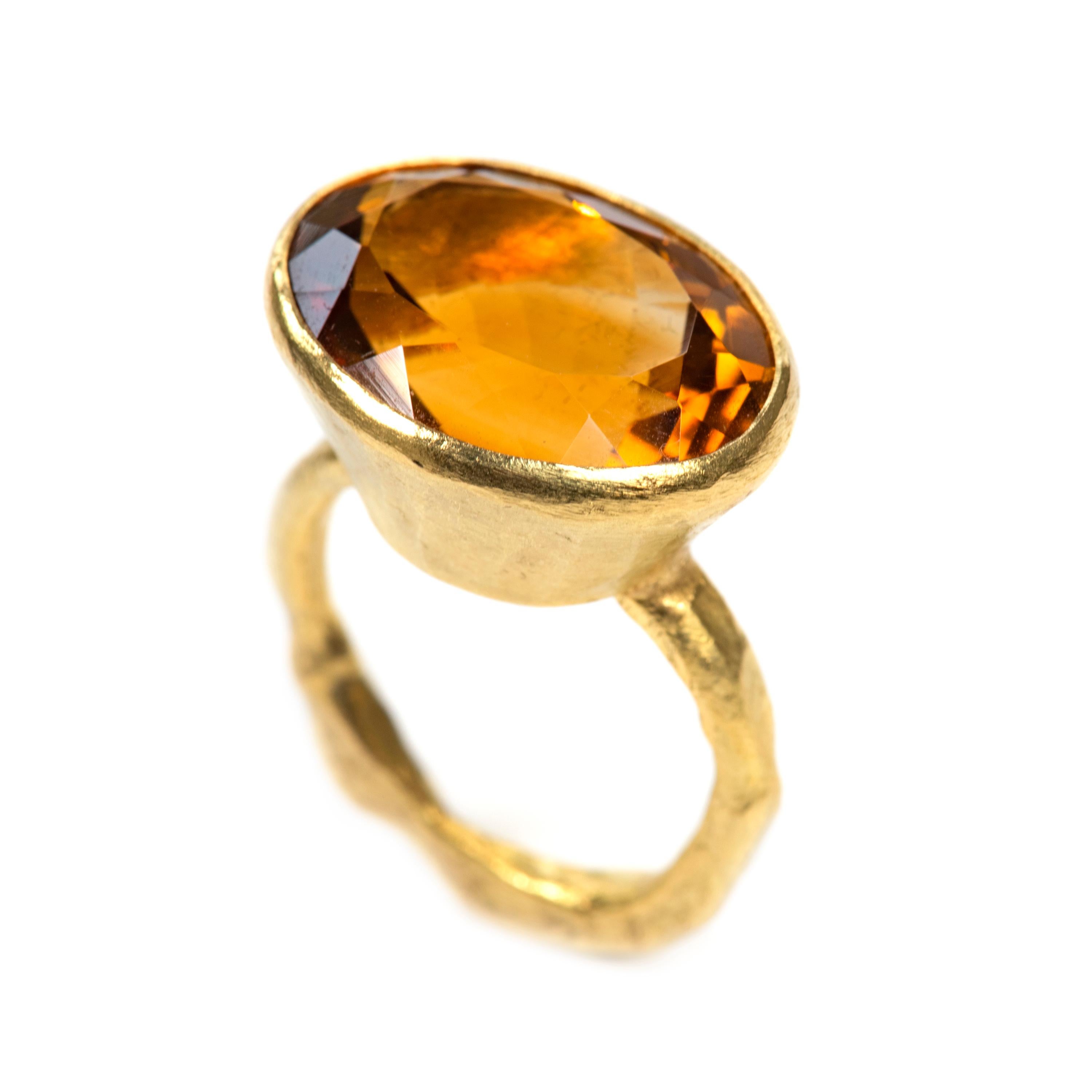 18k gold reticulated ring set with a large oval shaped citrine stone. The band measures 3mm wide, the citrine is approx 19cts and measures 16x21mm with a depth of 11mm. The ring features a tapered rub over setting to enhance and frame the