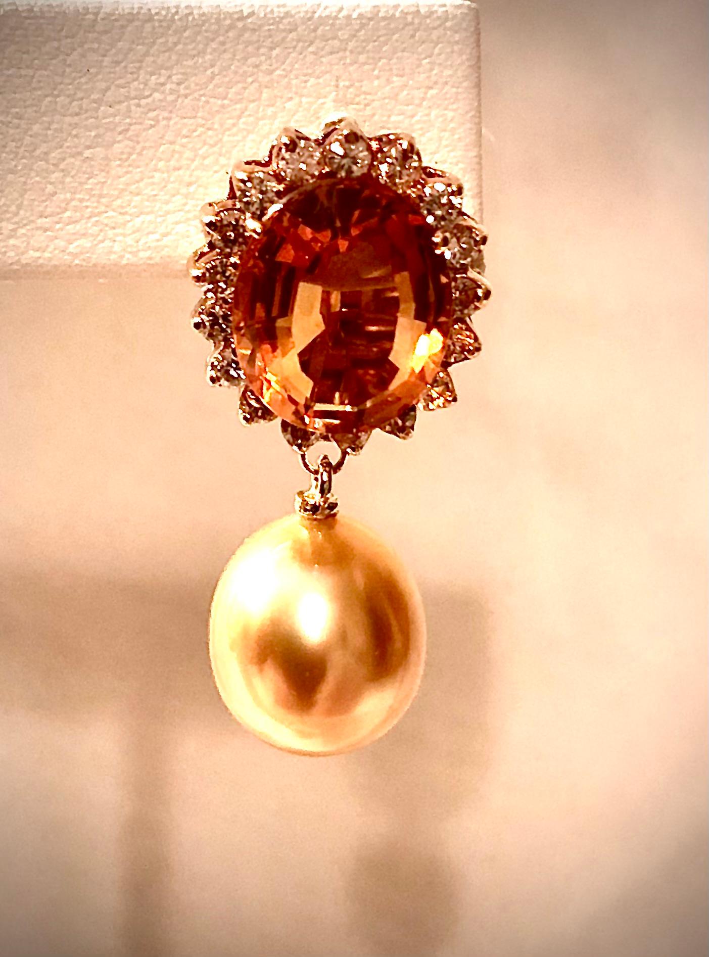 ﻿Elegant and beautiful earrings with large golden pearl. The lustrous golden approximately 12mm x 11mm oval pearls have a smooth shimmering nacre with very few blemishes.

The pearls are suspended from large well cut madeira citrine of a rich deep