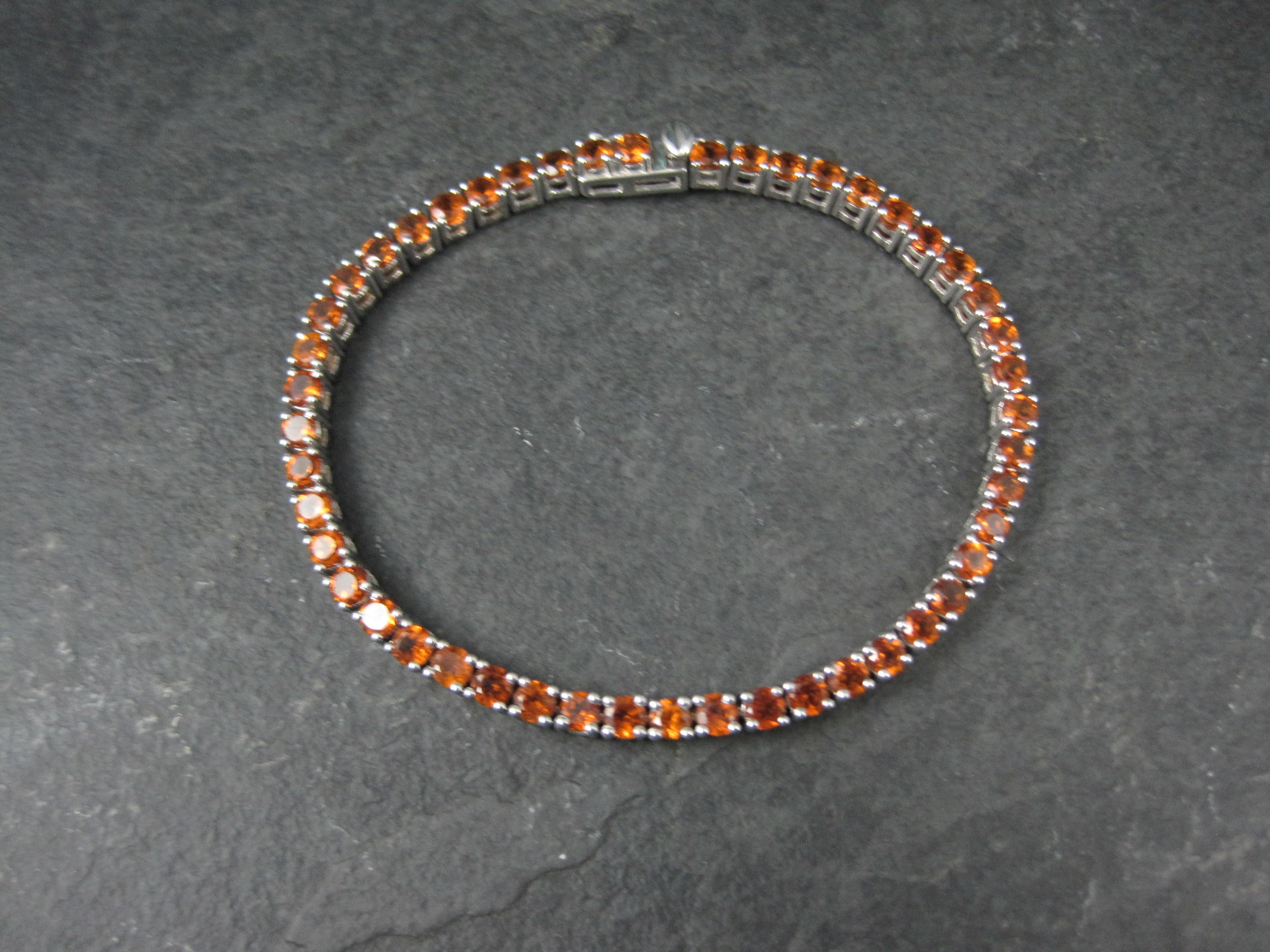This gorgeous tennis bracelet is sterling silver with a box clasp and safety catch.
It features 48 round cut 3mm Madeira citrine gemstones.

Measurements: 1/8 of an inch wide, 7 1/2 wearable inches
Weight: 13.4 grams

Condition: New old stock from