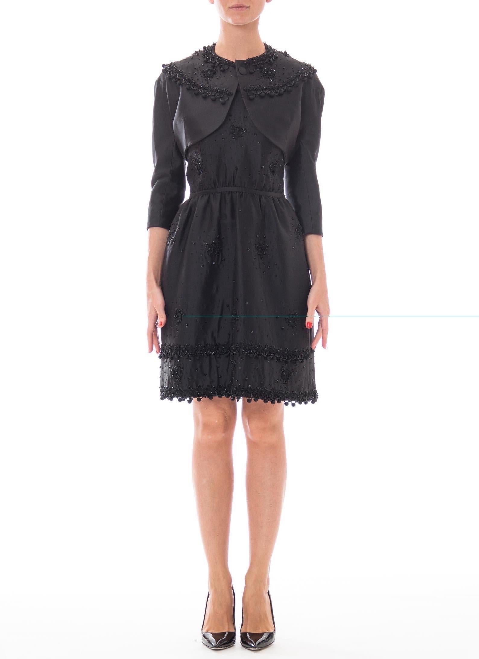 Exceptional quality, fully silk lined and hand finished. Very much in the Balenciaga Spanish style. MADELEINE DE RAUCH Black Haute Couture Silk Gazzar Passementrie Beaded Cocktail Dress With Cropped Bolero Jacket 