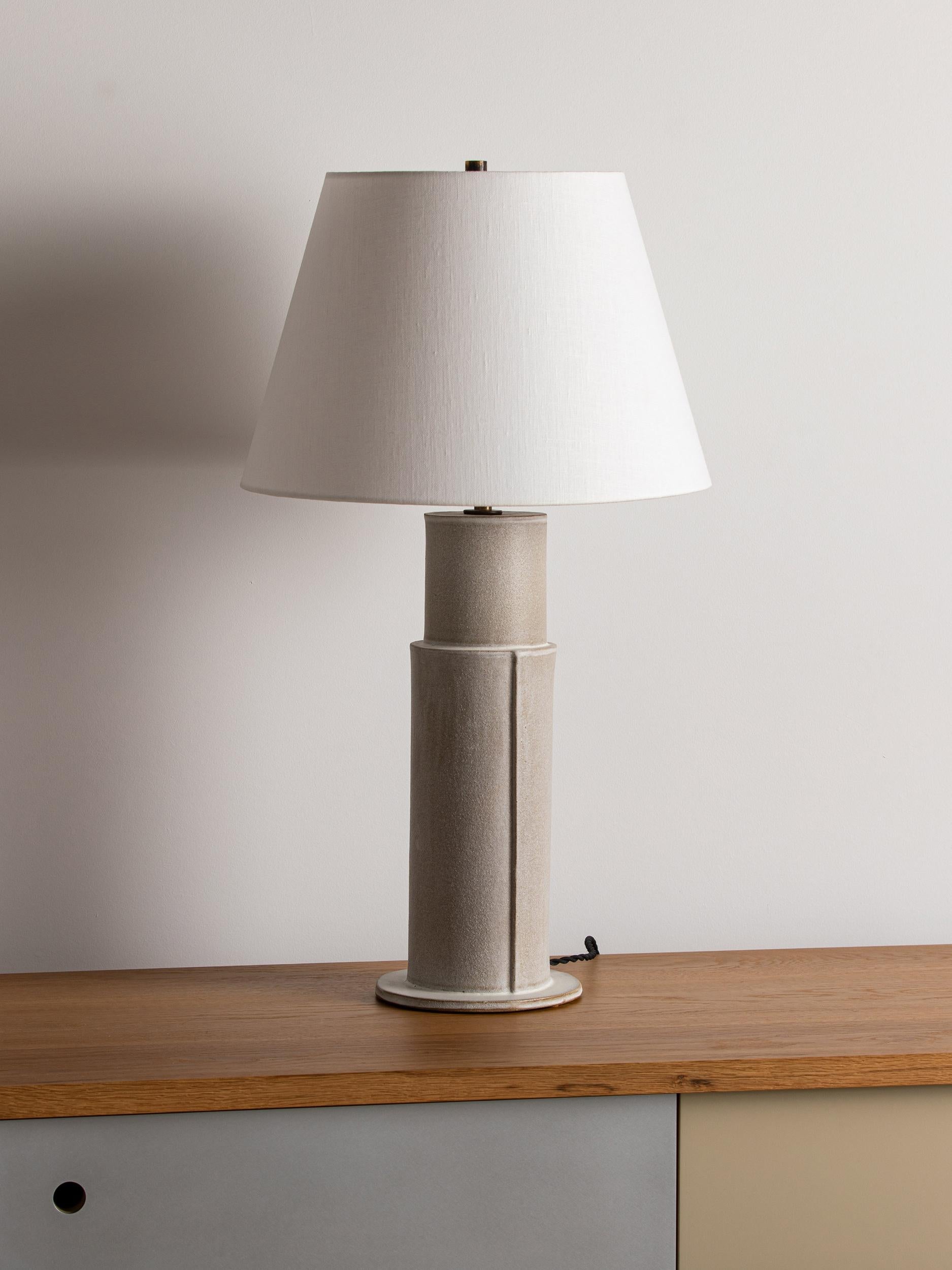 Our stoneware Madeline Lamp is handcrafted using slab-construction techniques.

Finish
- Dipped or poured glaze, pictured in ochre dipped
- Antique brass fittings
- Twisted black-cloth cord, Full-range dimmer socket
- Paper shade

BULB

75-watt