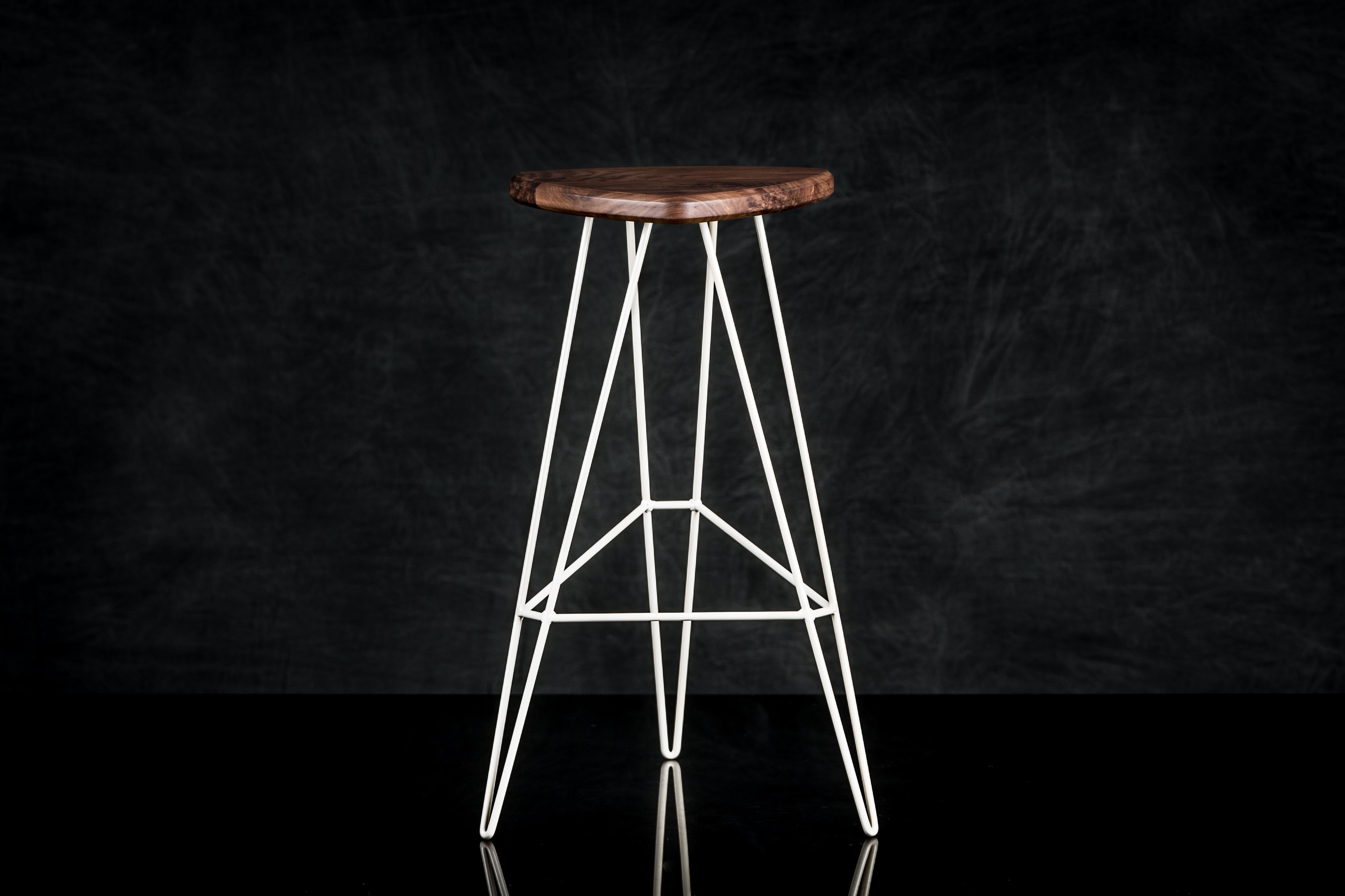 A well-designed piece of furniture blurs the line between functionality and art. The Madison stool is a geometrical masterpiece testing the boundary of what we think is possible with wire, balanced by the warmth and beauty of a natural wood seat. No