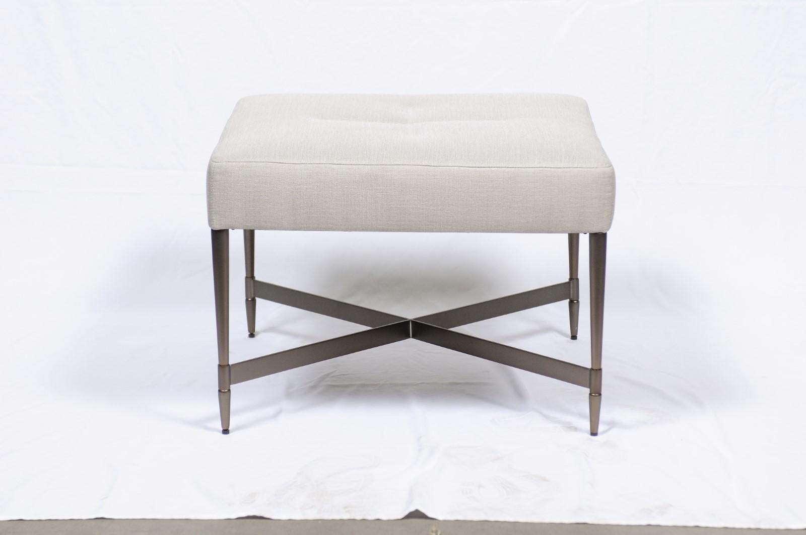 The simple seat has a dressmaker detail of tight stitching while the bronze legs and X-stretcher sit atop a finely turned foot. A useful addition to any room, the Madison Square Tabouret offers impromptu seating or a cocktail table alternative.