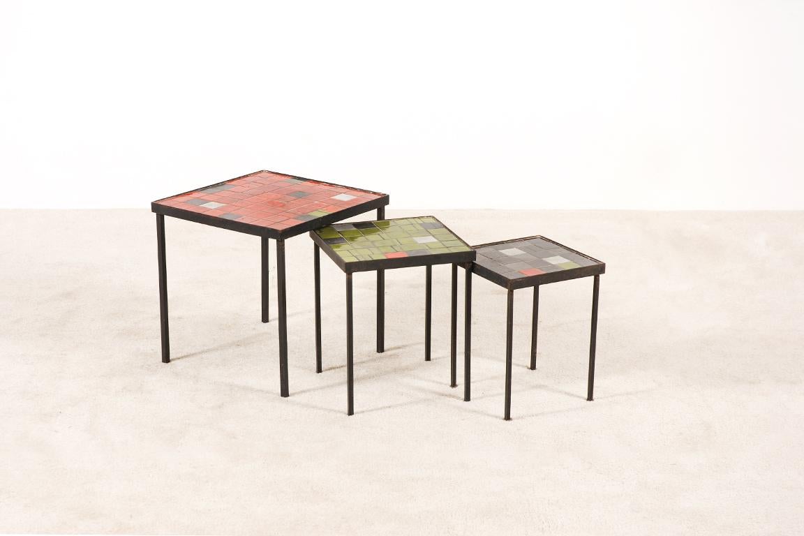 Rare set of 3 nesting tables by the ceramists Mado Jolain and René Legrand.
The tops are made of ceramic tiles and the frames are in black wrought iron.

Red table: 41 cm x 41 cm x H: 41 cm
Green table: 31 cm x 31 cm x H: 37.5 cm
Black table: