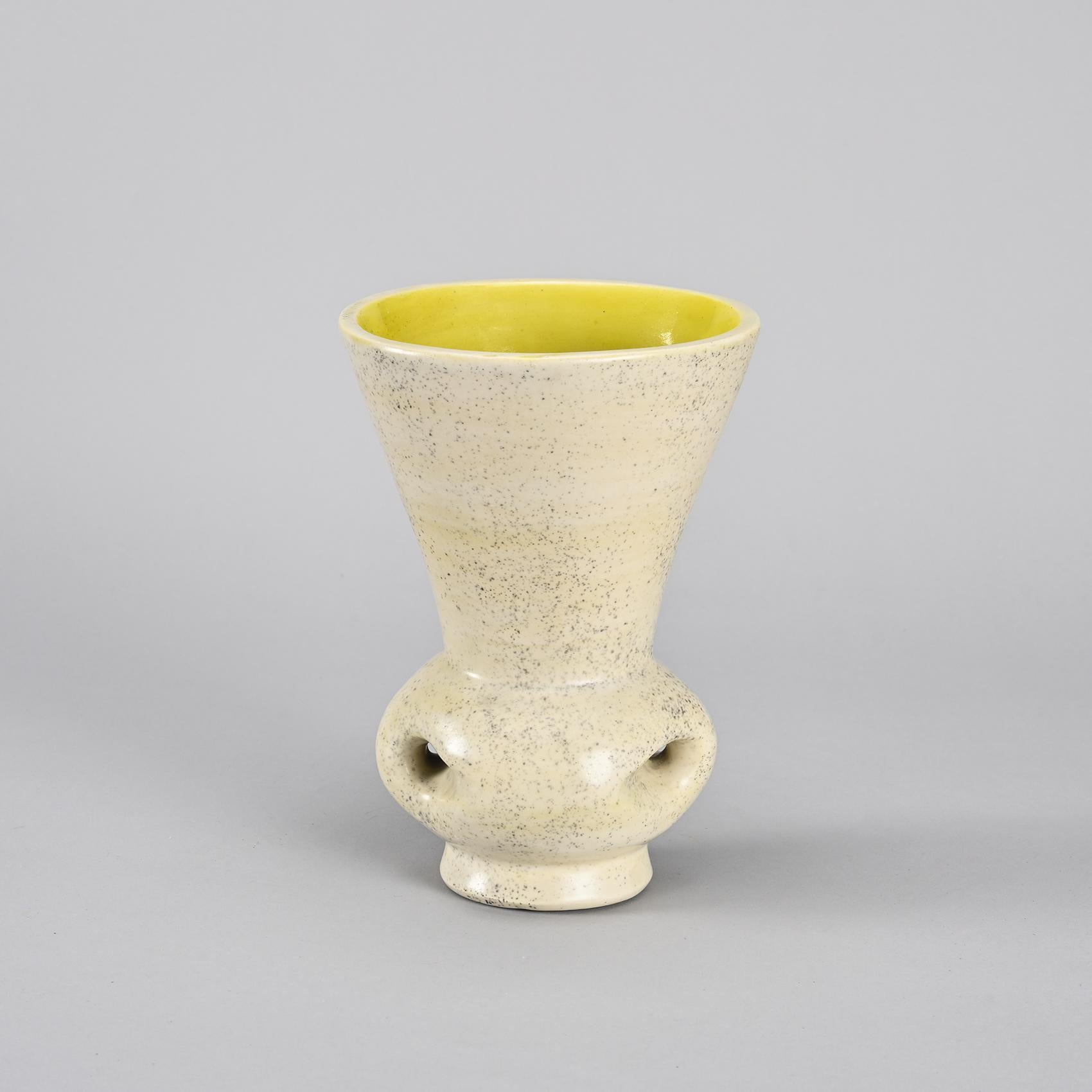 A pretty vase with handles by Mado Jolain, a French ceramicist active from 1946 to 1970.
Completely made of white clay covered with a milky white glaze speckled with lemon yellow on the interior.
Circa 1950.
Marked on the back with the shape number