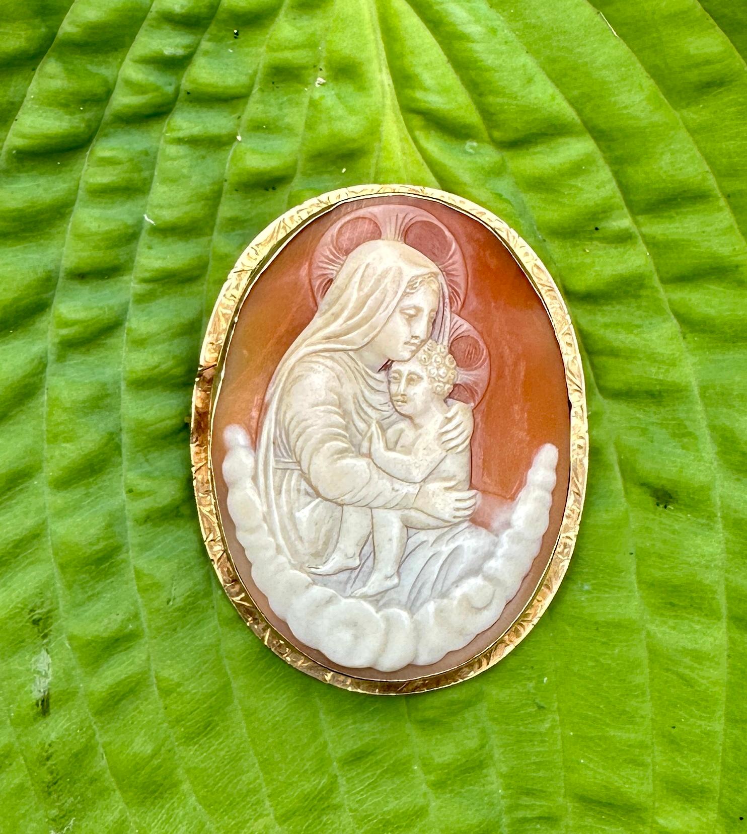 This is an absolutely stunning and very rare early antique Victorian - Belle Epoque Shell Cameo Pendant Brooch Pin with an exquisite museum quality hand carved image of the Madonna with Child set in a gorgeous engraved 14 Karat Yellow Gold frame.  
