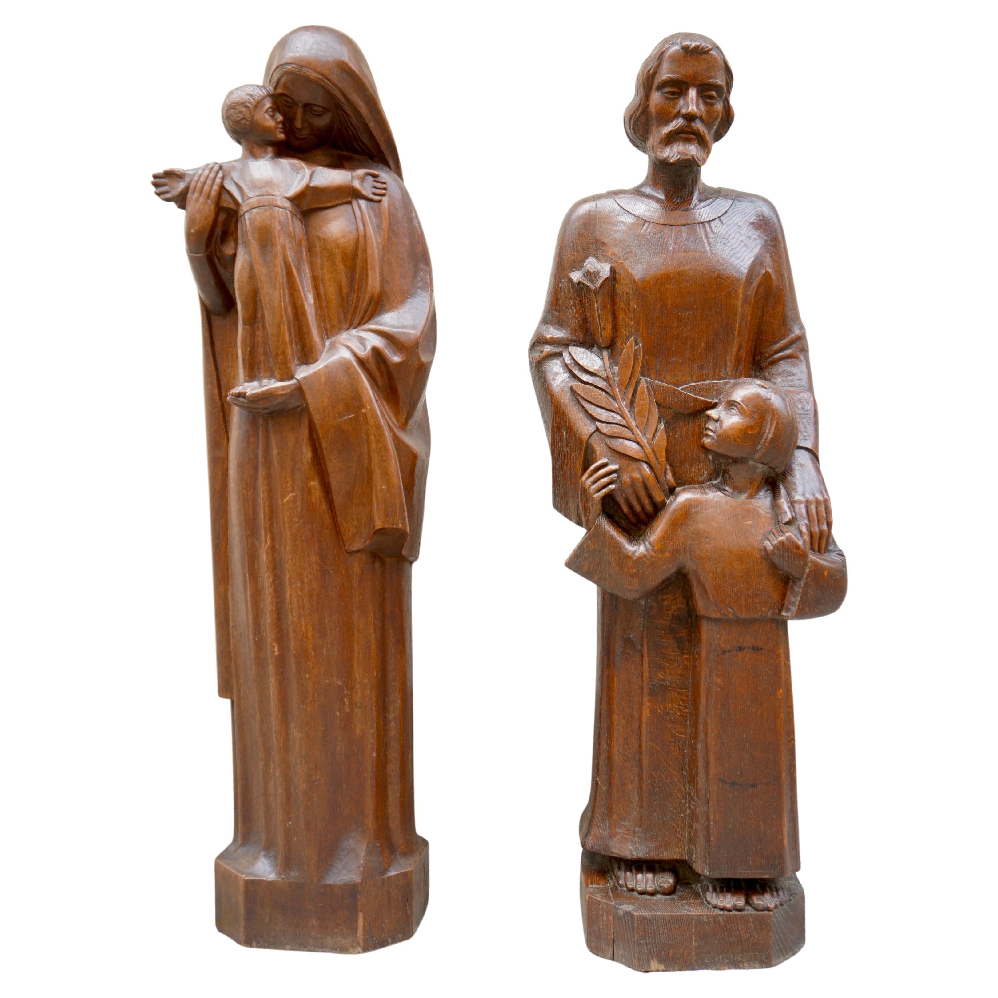 Two large sculptures statue in oakwood, representing Saint Joseph and child and the Madonna and child, standing on her arm.In the style of Hildo Krop, Amsterdam school style.
Signed E. Henrotte,1939.Belgium.

Madonna
Height 56.6