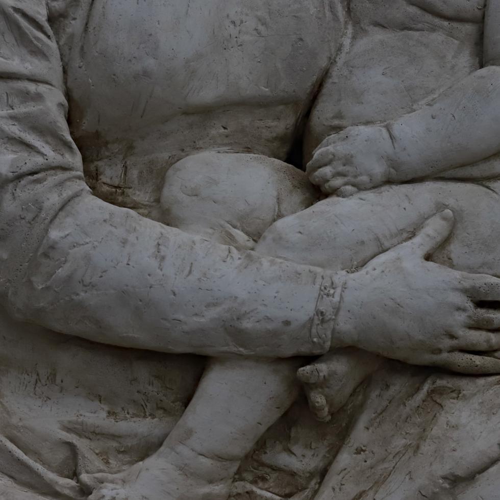 This round low relief is a singular artwork crafted by sculptor Raffaello Romanelli in 1896 and exhibited in the monument for Donatello in the Saint Lawrence Basilica in Florence. The symbolic meaning, hinting at the sense of protection a mother has