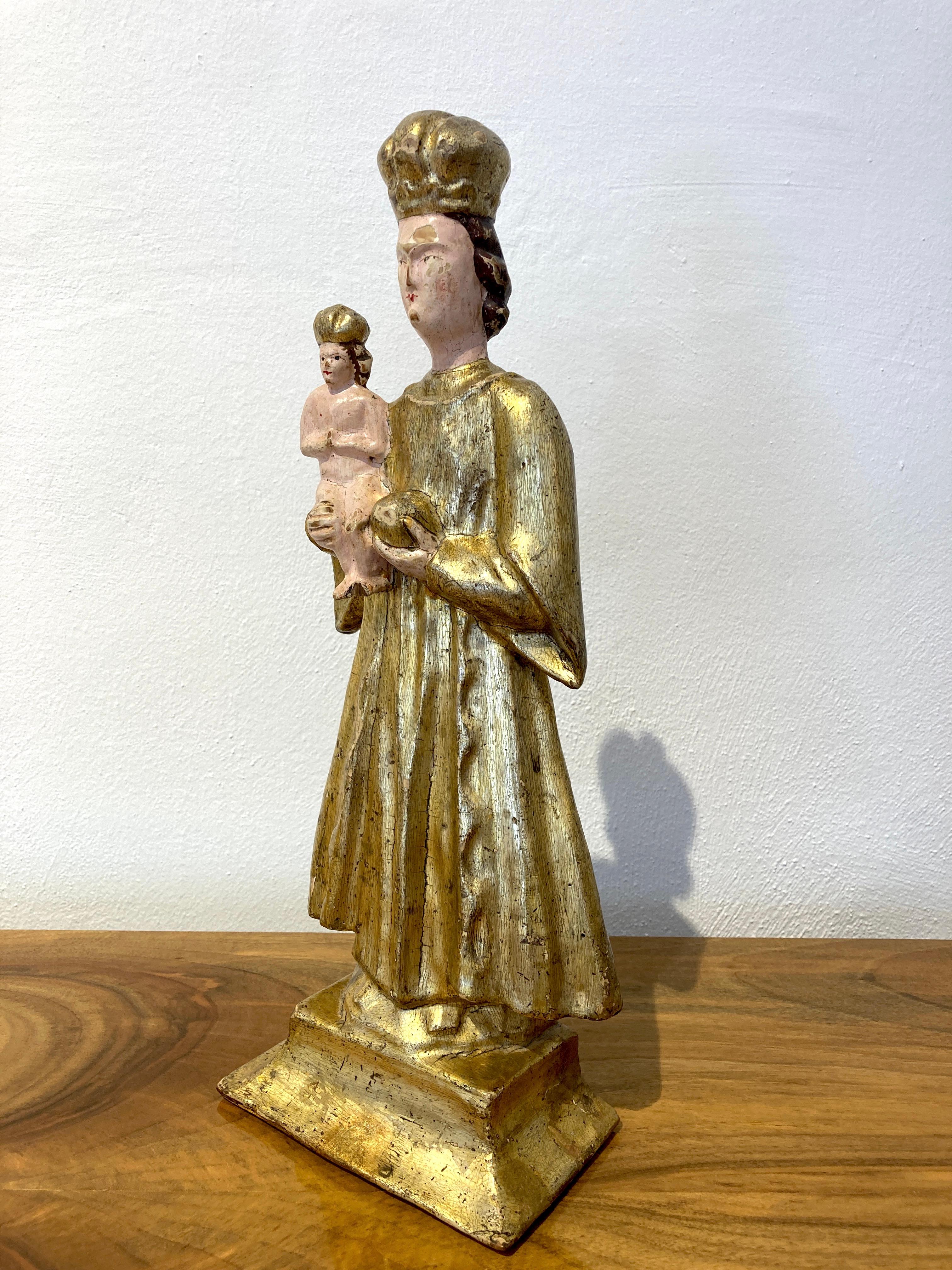 Madonna with child Pribram Bohemia Mid 19th Century.
Wood carved Madonna with original polychrome painting, mostly gilded.
Crosses on the crowns are missing, good condition.
Traces of an old restoration on the base.