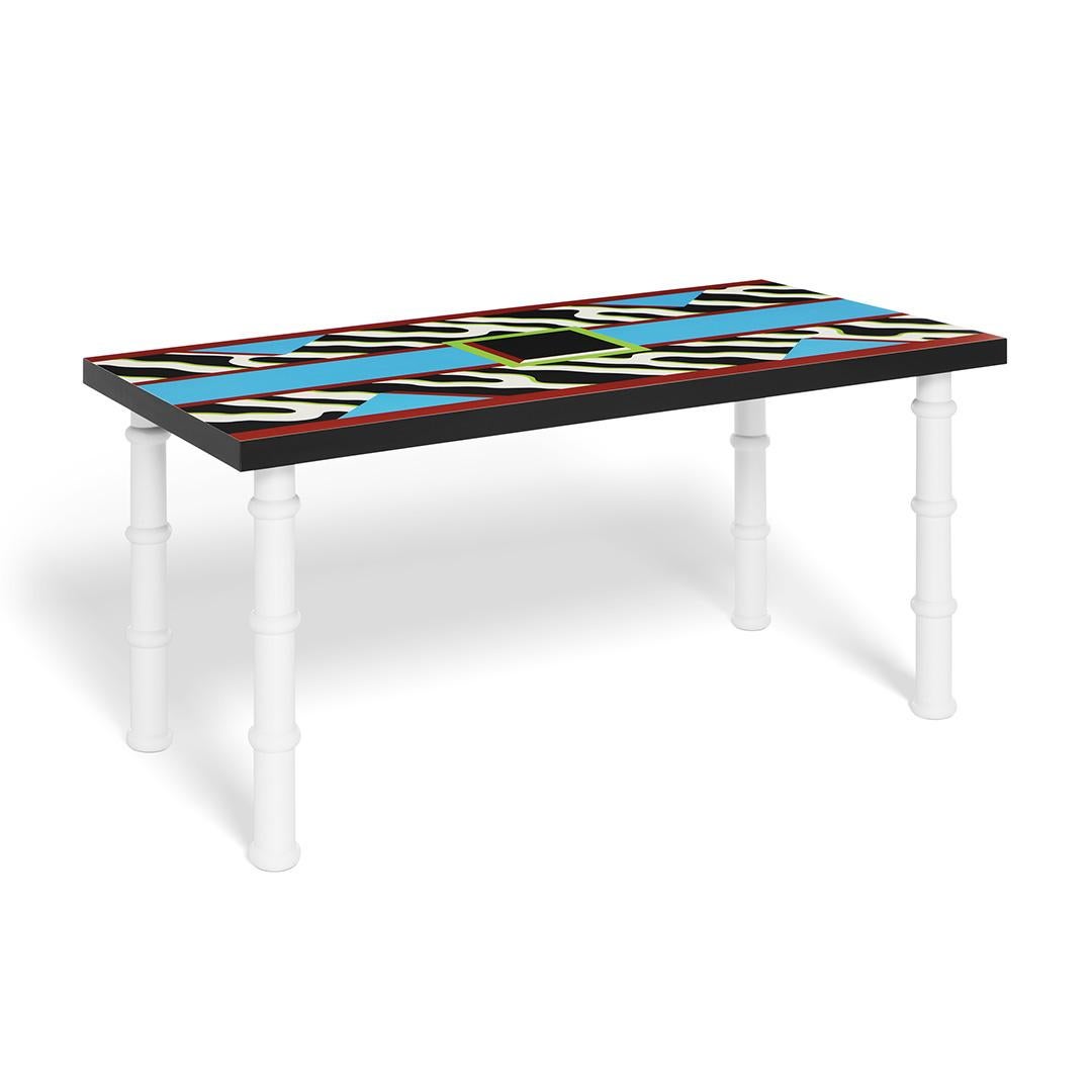 The Madras table has a beautiful contrasting laminate pattern top, designed in 1986 by Nathalie du Pasquier. 

Nathalie du Pasquier was born in Bordeaux, France, in 1957.She has lived and worked in Milano since 1979. Until 1986 she worked as a