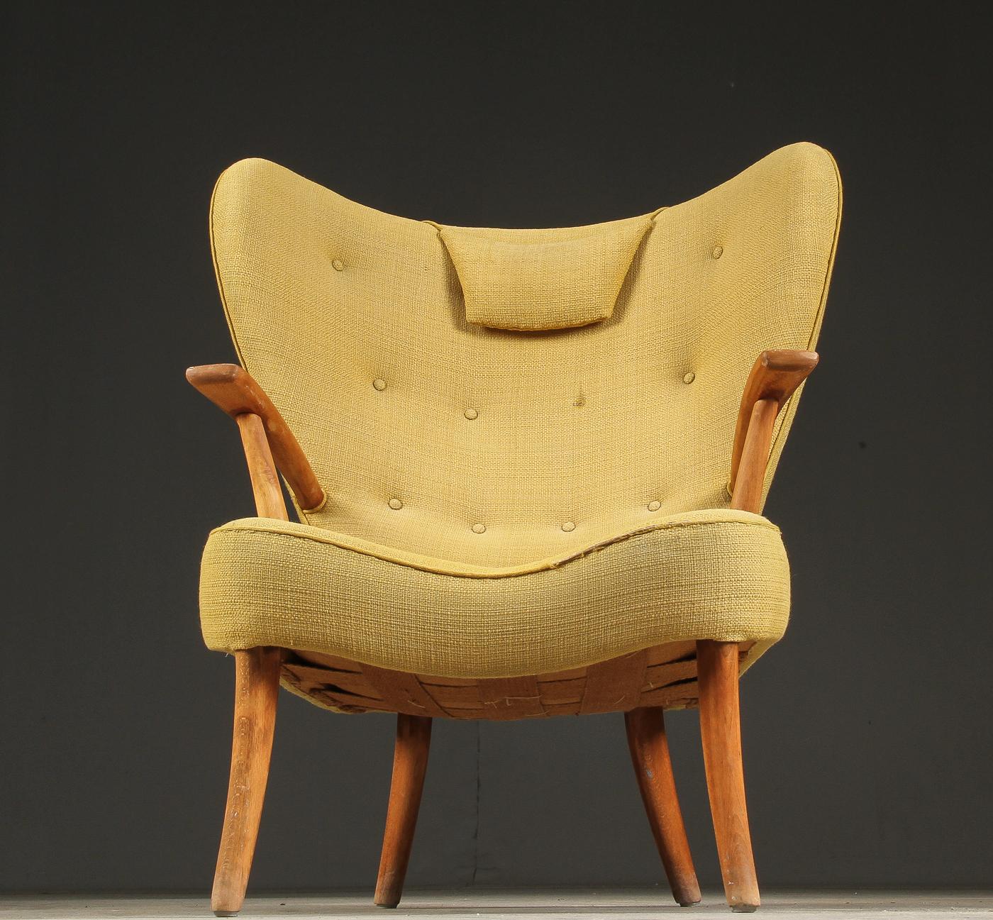 Sculptural lounge chair with beech, back, neck pillow and seat cushion upholstered in yellow upholstery fabric. Designed in 1954 by Ib Madsen & Acton Schubell, Rungsted (Copenhagen) Denmark. The chair comes with slight patina. At an additional cost,