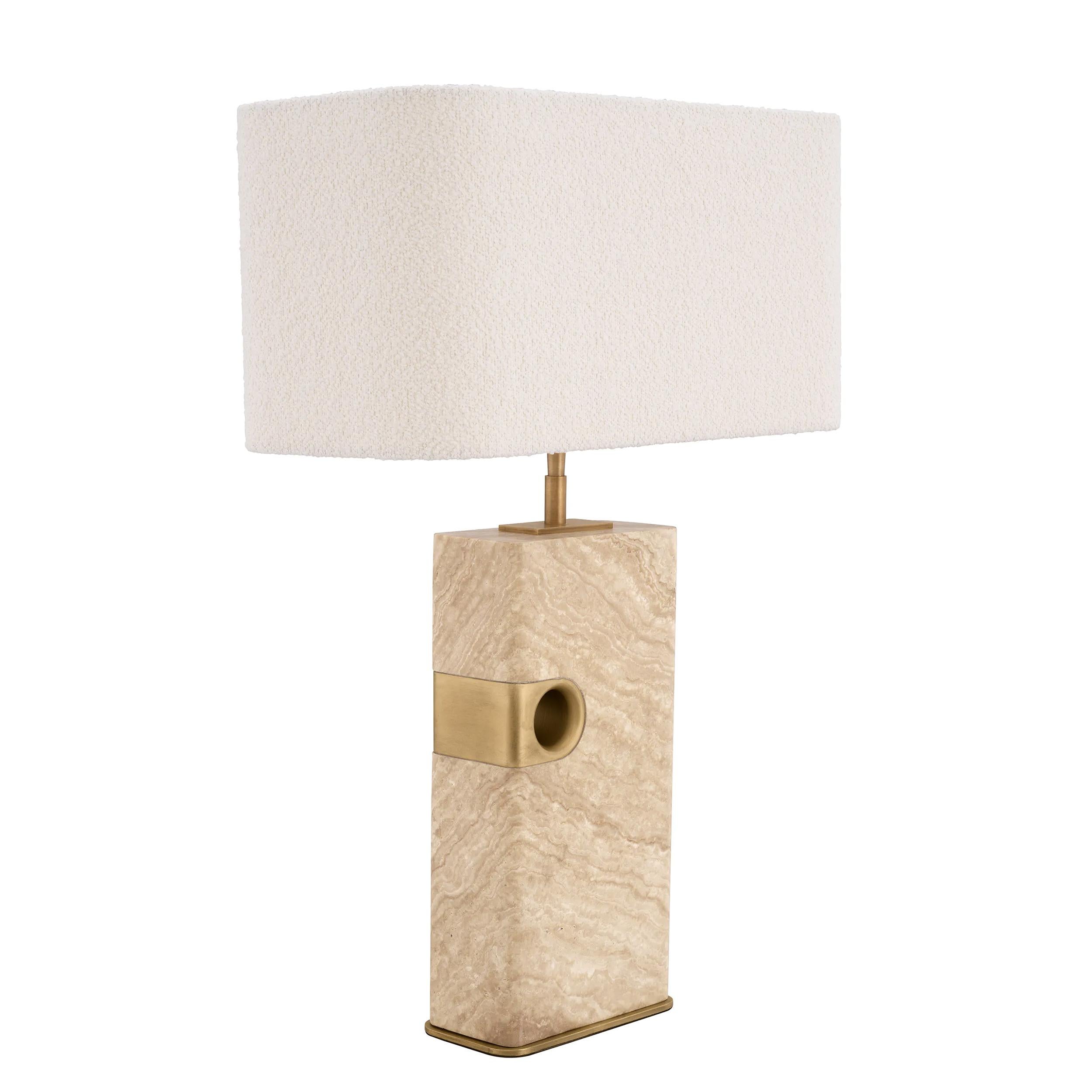 Table Lamp Madura with base in carved and polished travertine
with solid brass details in brushed vintage finish. Including shade
in bouclé fabric with steel frame. 1 bulb, lamp holder type E27, max
40 watt. bulb not included. Shade dimensions: