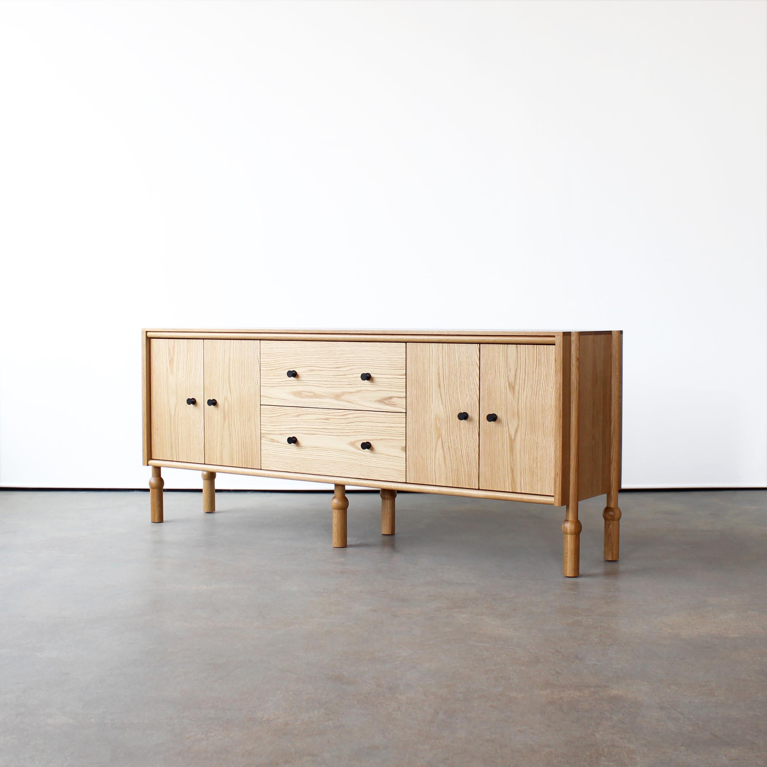 Mae Credenza by Crump and Kwash 

Solid wood case / hand-turned legs / hand rubbed oil finish / solid brass pulls / premium, full extension, soft close drawer slides / solid wood, dovetailed drawer boxes

Dimensions: 72” W x 18” D x 30”