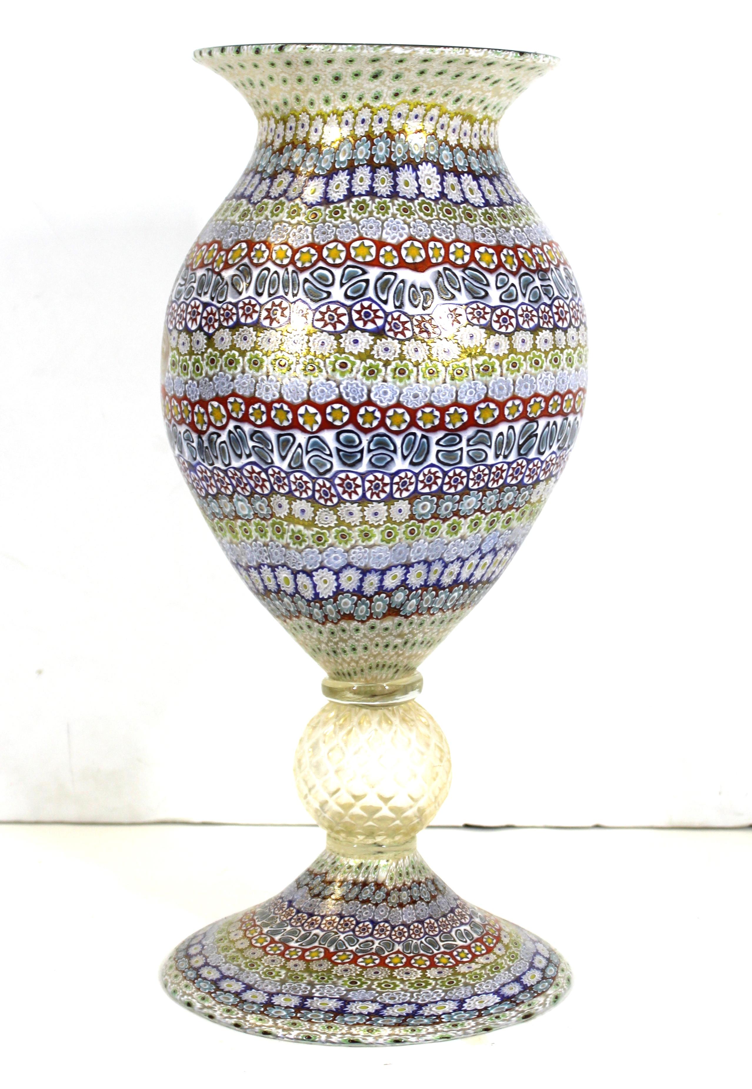 Italian Murano glass monumental millefiori vase created by Maestro Imperio Rossi during the late 20th century on the famed island of Murano in Venice. The piece is crafted of innumerable glass murrine depicting minuscule flowers into a grand vase