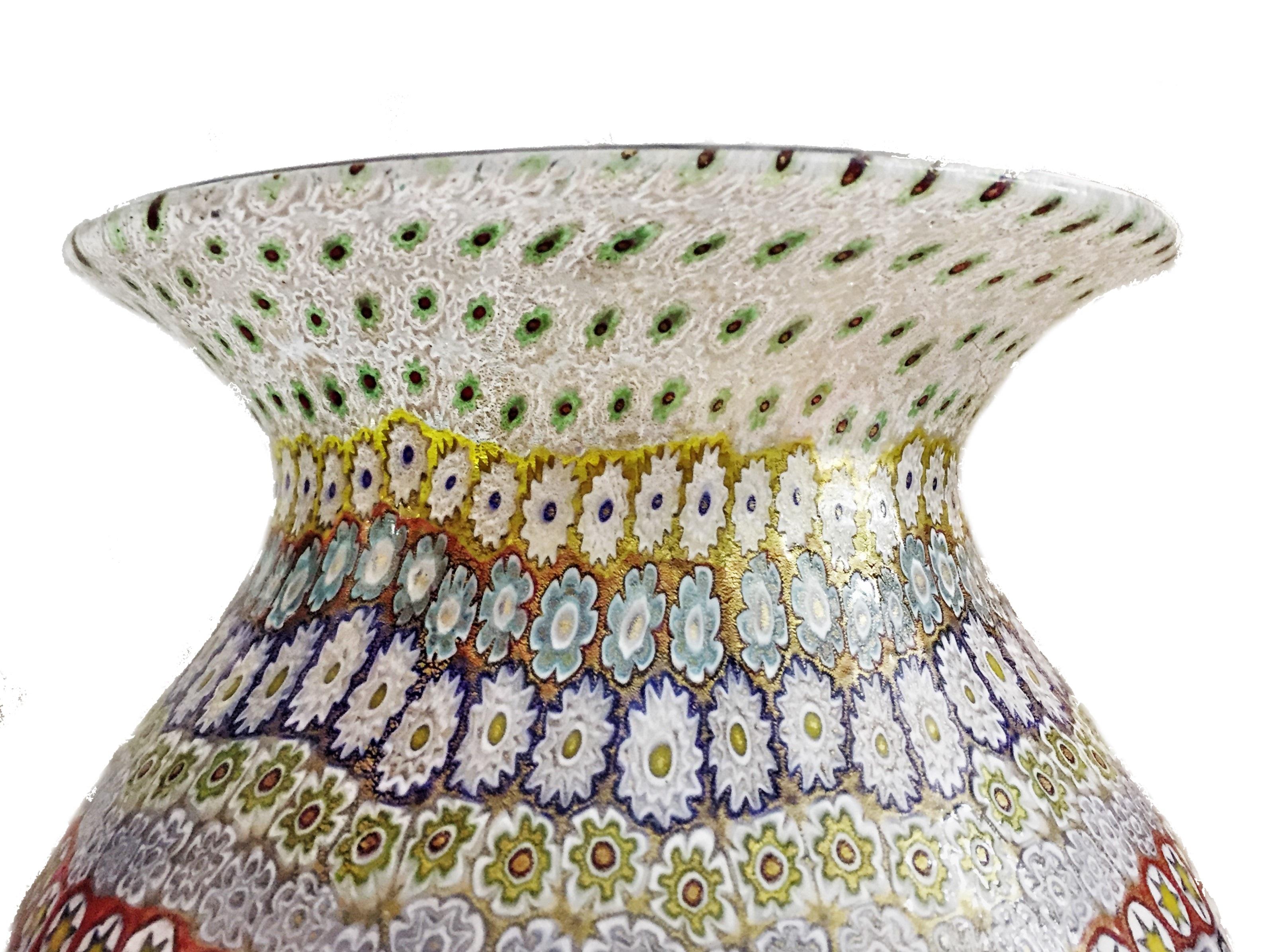 Dimensions:
Height 18-3/4 inches 
Diameter 8-3/4 inches

Found in the middle section of the vase’ neck, there is a round glass medallion with letter “m”, indented into it for Maestro Imperio Rossi.

This grand Murrine Millefiori decorative