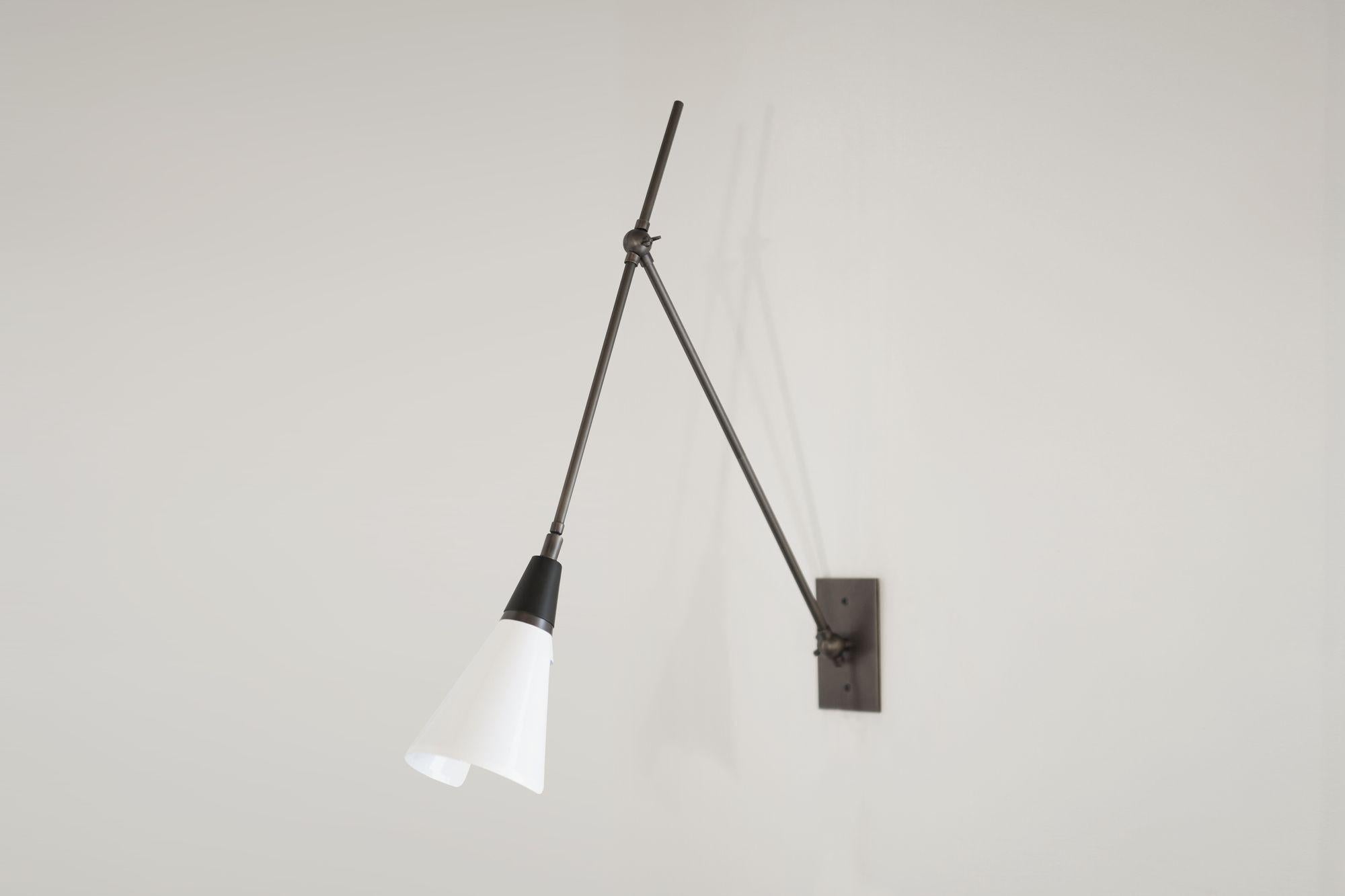 The Magari wall lamp or reading light is handmade to order. Magari is adjustable to suit your needs: there are two articulating joints, and the shade has a swivel mechanism for rotation. This design is strongly influenced by both French and Italian
