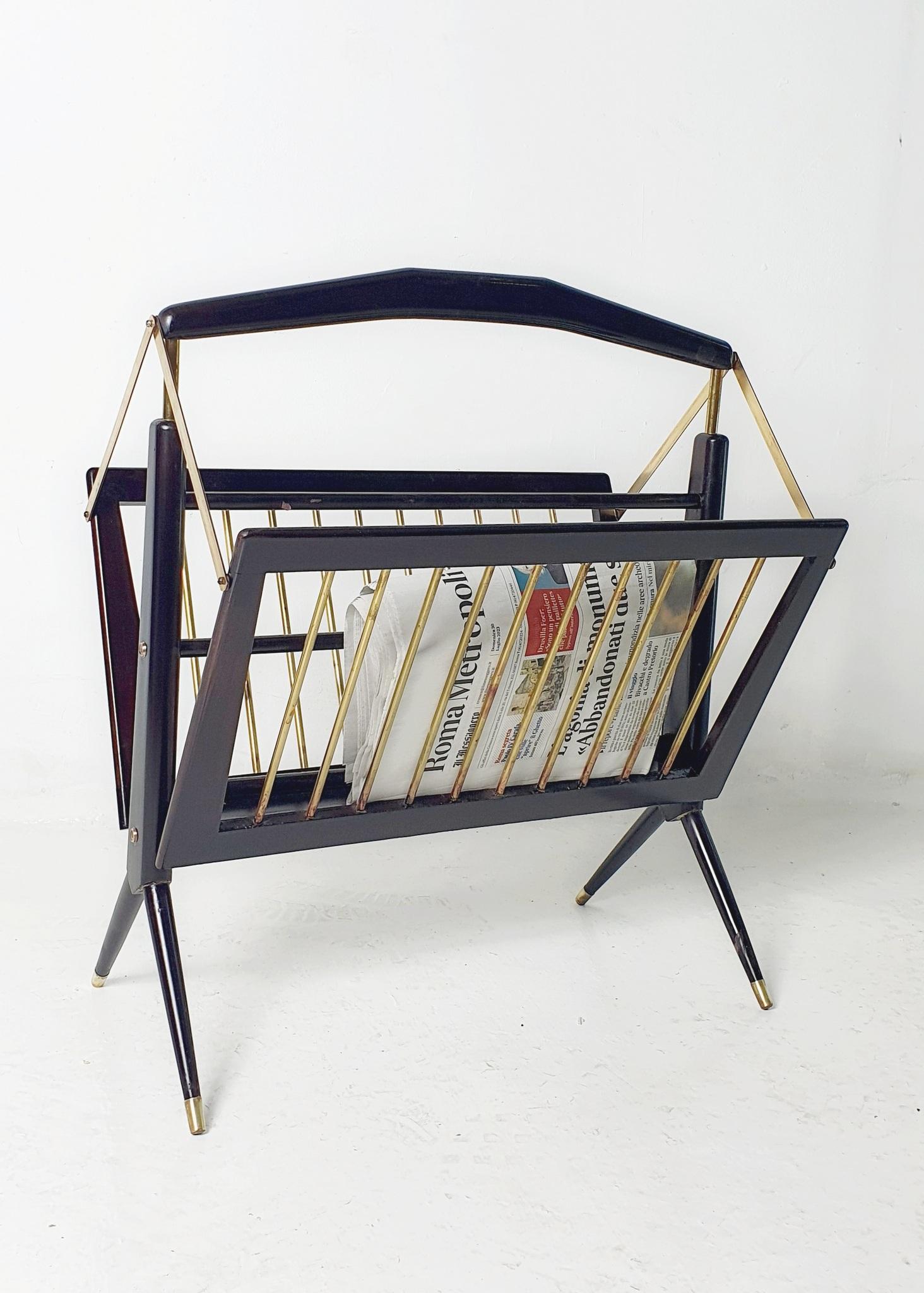 Mid century 1950's foldable magazine rack in stained beech wood and brass detailing. Has been professionally restored.