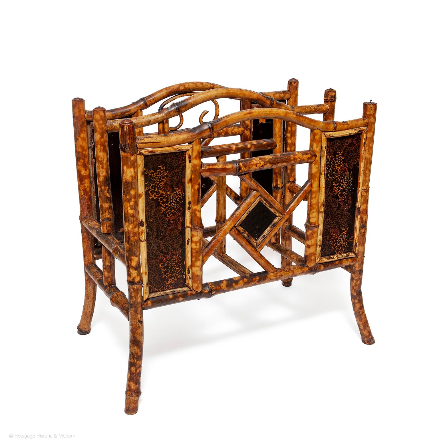 The bamboo frame is painted to simulate tortoishell which you see on the finest pieces. The centre of each side has a fretwork panel with central ebonised plaque and a pair of floral lacquer panels either side, possibly Japanese lacquerwork. Typical