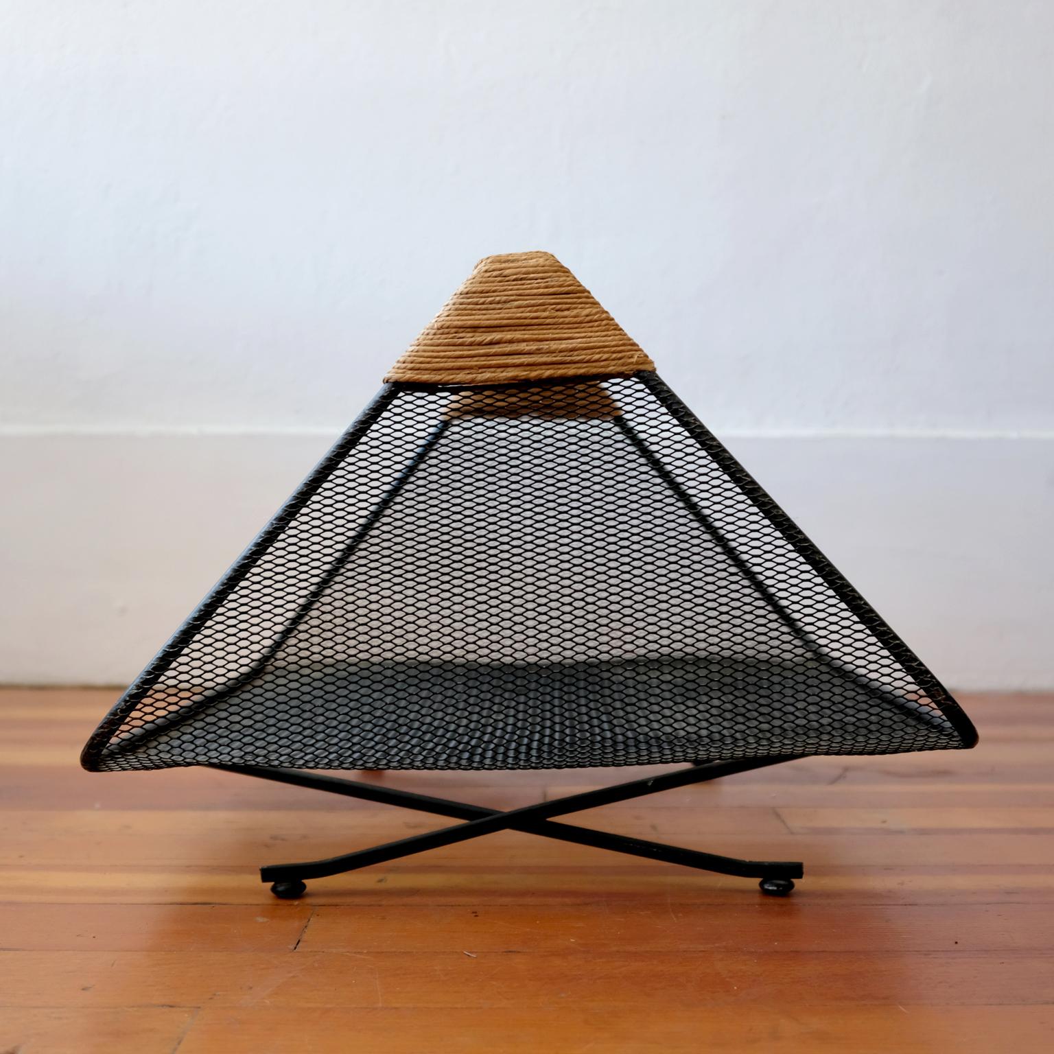 Magazine or log holder by Tony Paul for Woodlin-Hall. Iron frame, mesh body and rush-wrapped handle, 1950s.