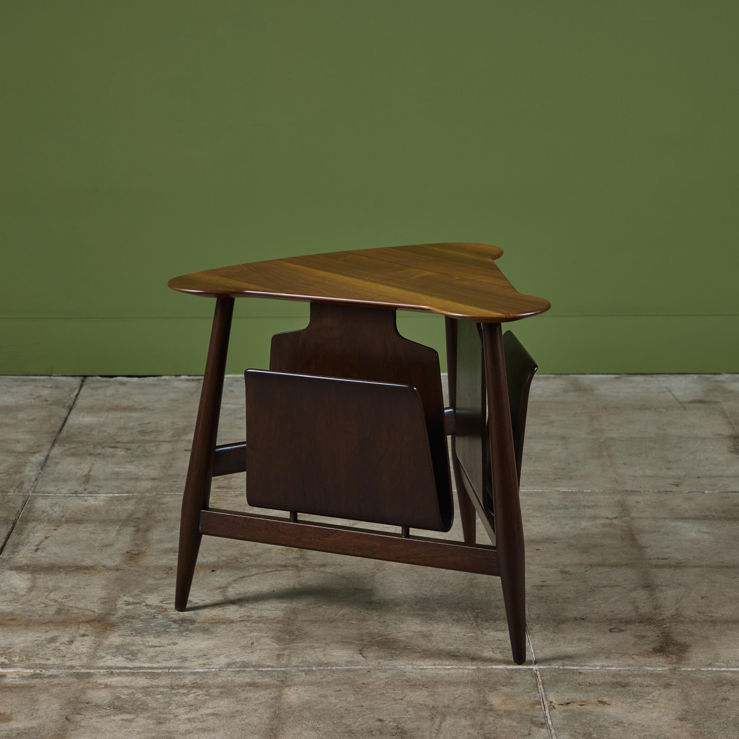 Triangular walnut and mahogany side table by Edward Wormley for Dunbar c.1940s, USA. The table, model - 5313, showcases a triangular walnut table top with rounded corners and a mahogany base with two sleeves for magazine storage/display. Retains the