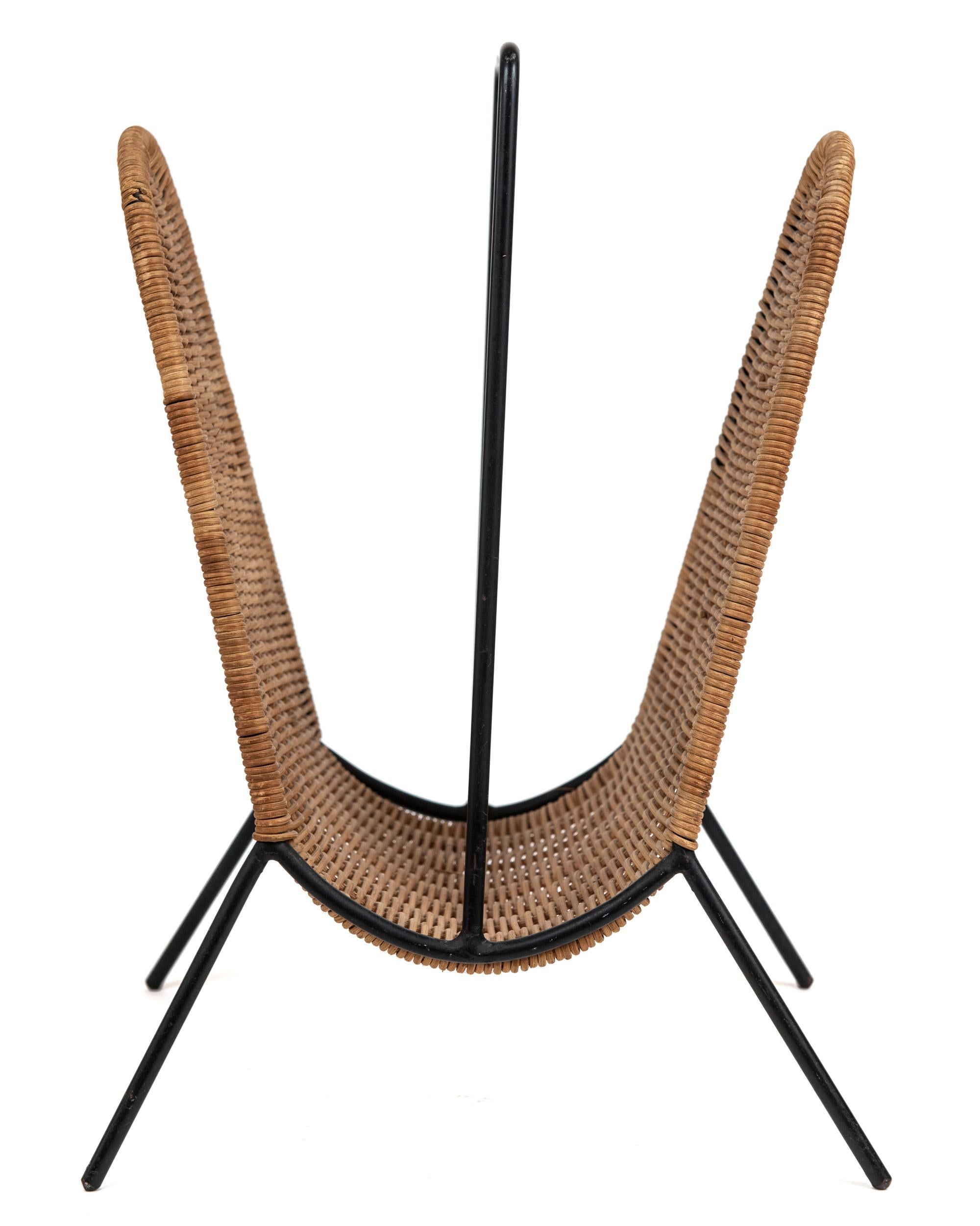 A cool and rare black wrought iron and rattan magazine stand attributed to Austrian modernist designer Carl Aubock. I love this piece for its sculptural simplicity.