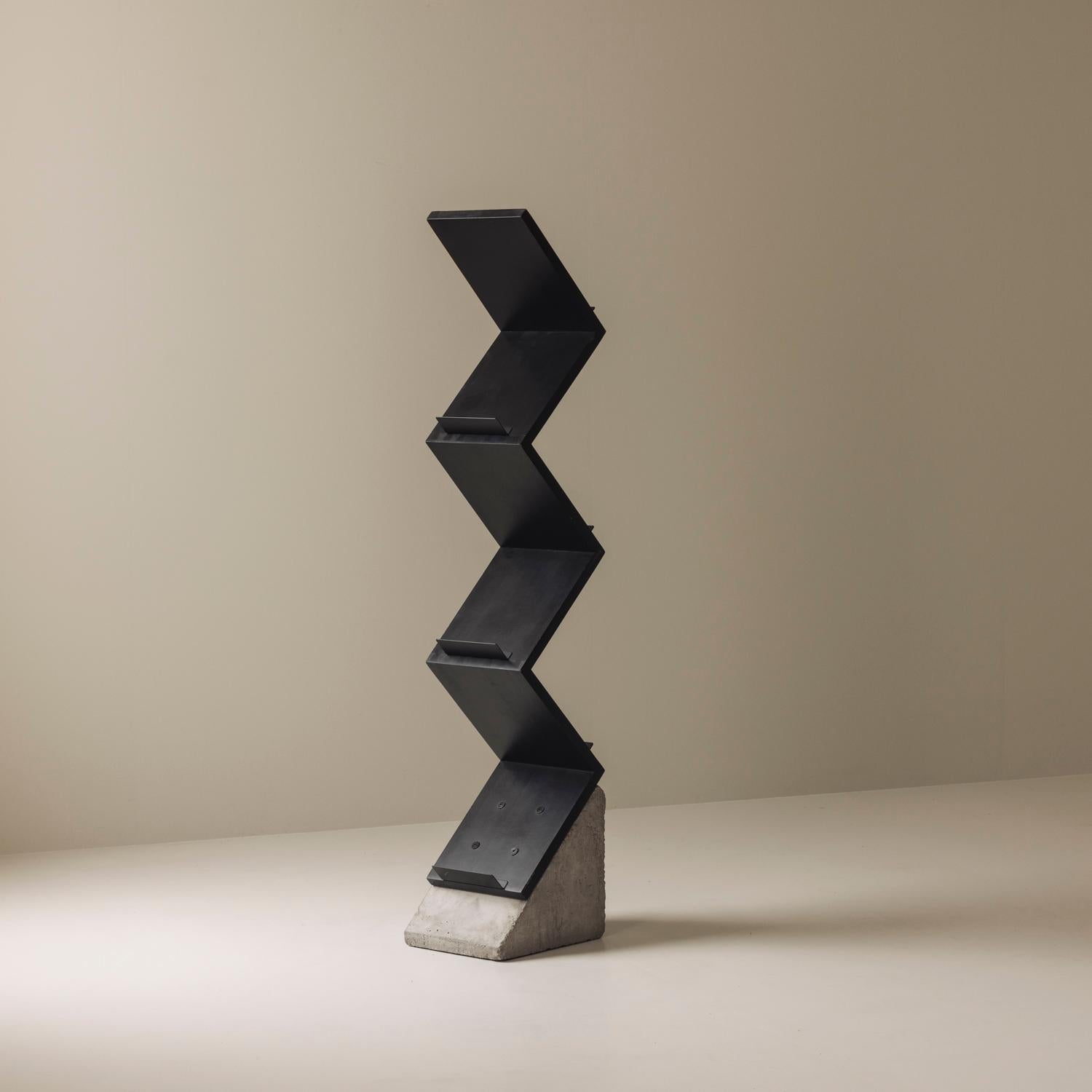 A striking example of Swedish postmodern design, this magazine ‘Zink’ shelf by Jonas Bohlin for Källemo blends industrial edge with sculptural elegance. Designed in 1984 and crafted from concrete and wood, its distinctive zig-zag form creates a bold