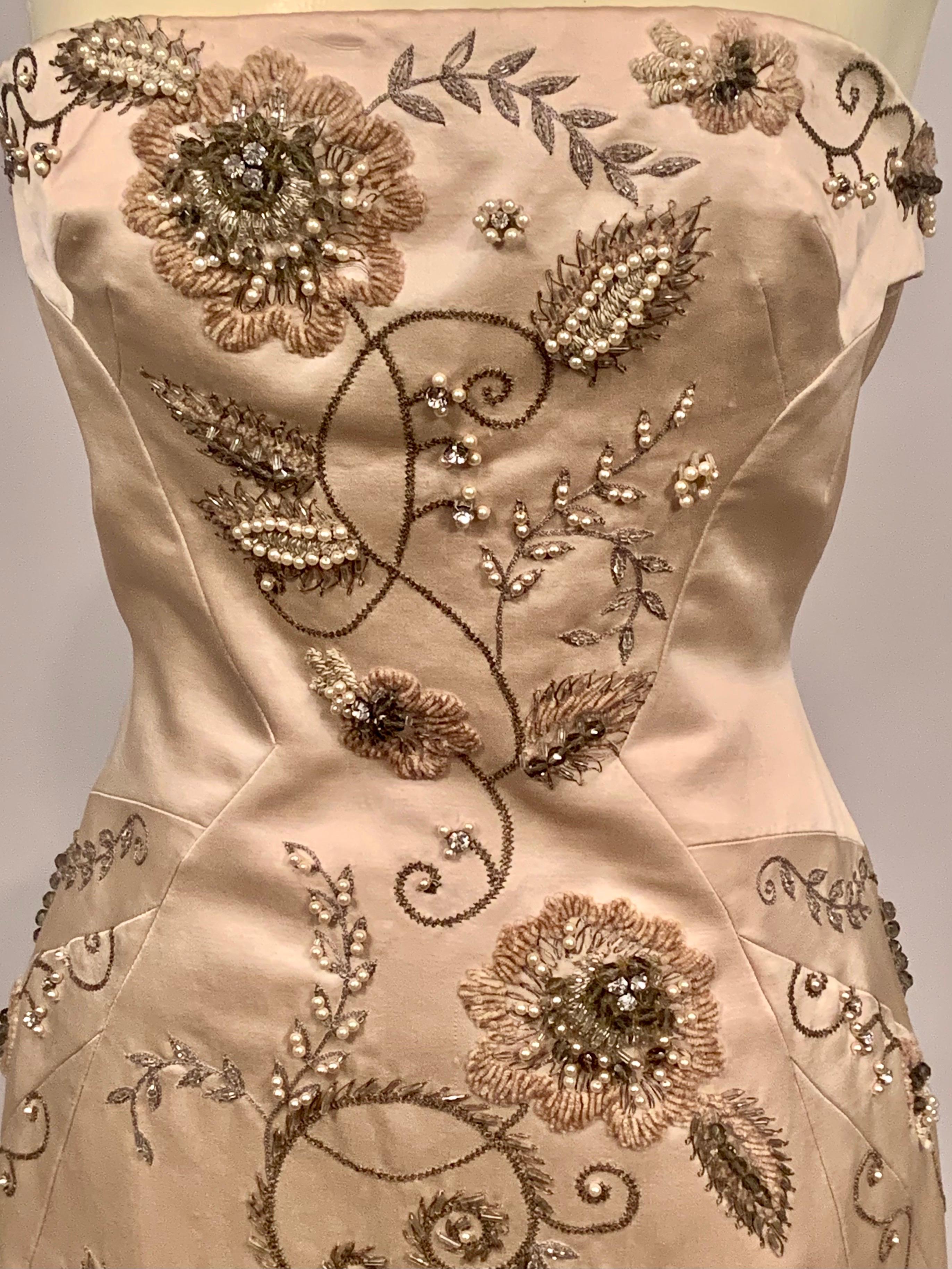 This is such a beautiful champagne colored strapless gown with a train, designed by Maggie Norris, the former Senior Design Director of Womenswear at Ralph Lauren.  The dress has a beaded band at the bustline and the design of flowers, vines and