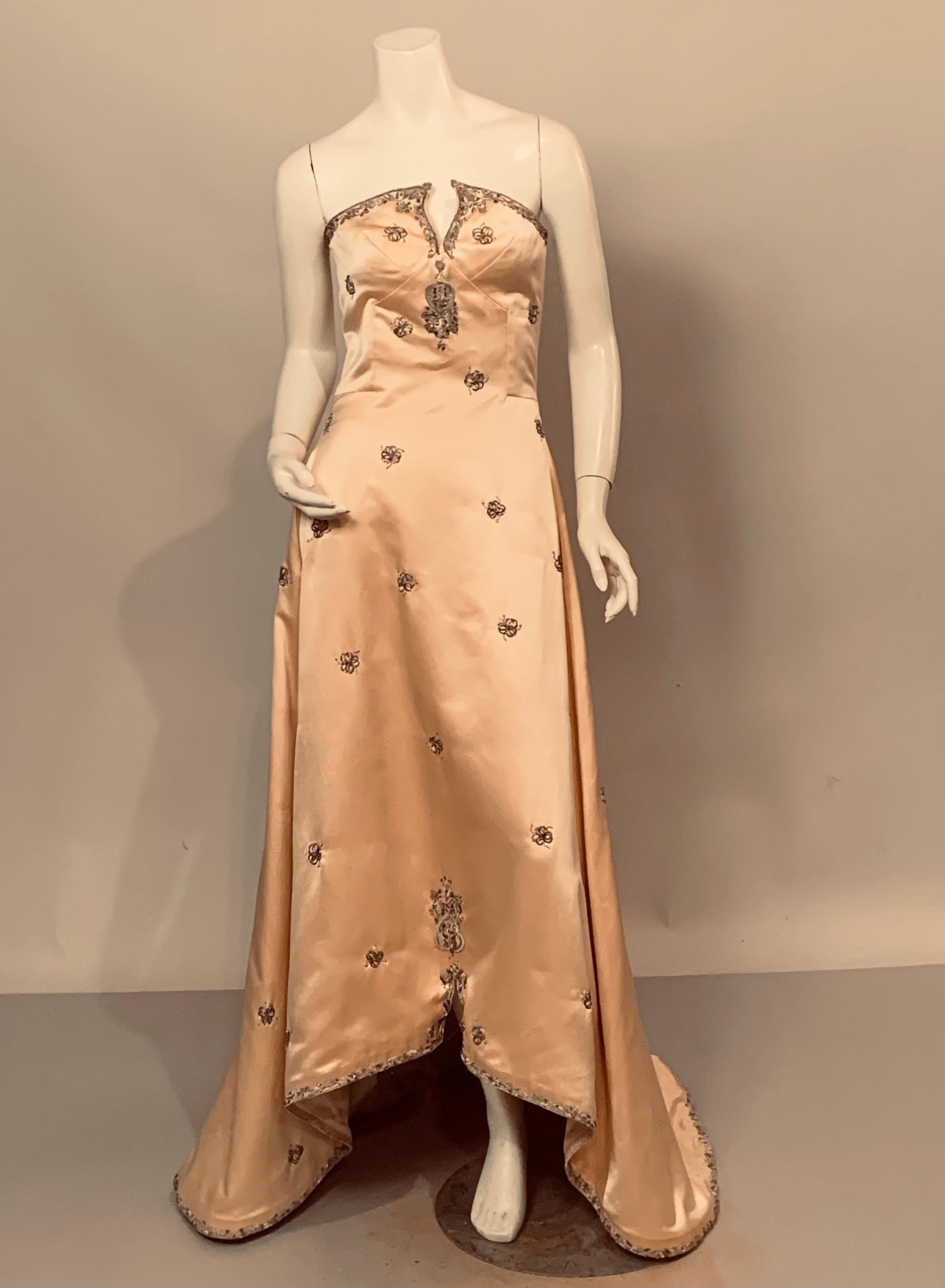 This is an absolutely beautiful strapless shell pink silk satin evening gown with a train and silver metallic hand embroidery. This piece does not have the tag but I do believe the embroidery is by Lesage, Maggie used it in many of her pieces and