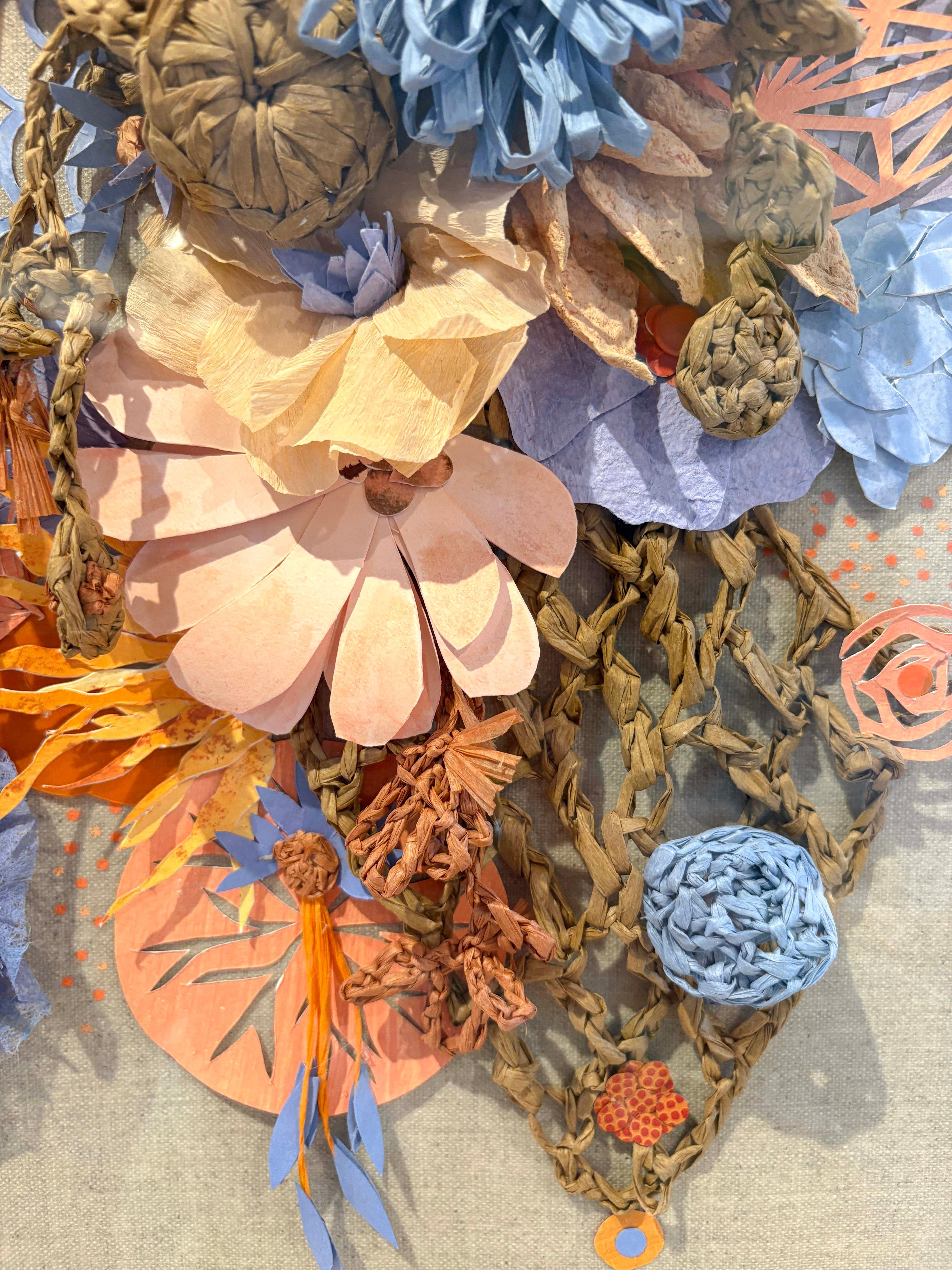 This floral relief sculpture by Maggie Ramirez-Burns uses vintage and handmade paper to create a cascade of un-natural beauty. It's expertly framed in an acrylic box to protect the delicate structure.

Maggie Ramirez Burns creates work that