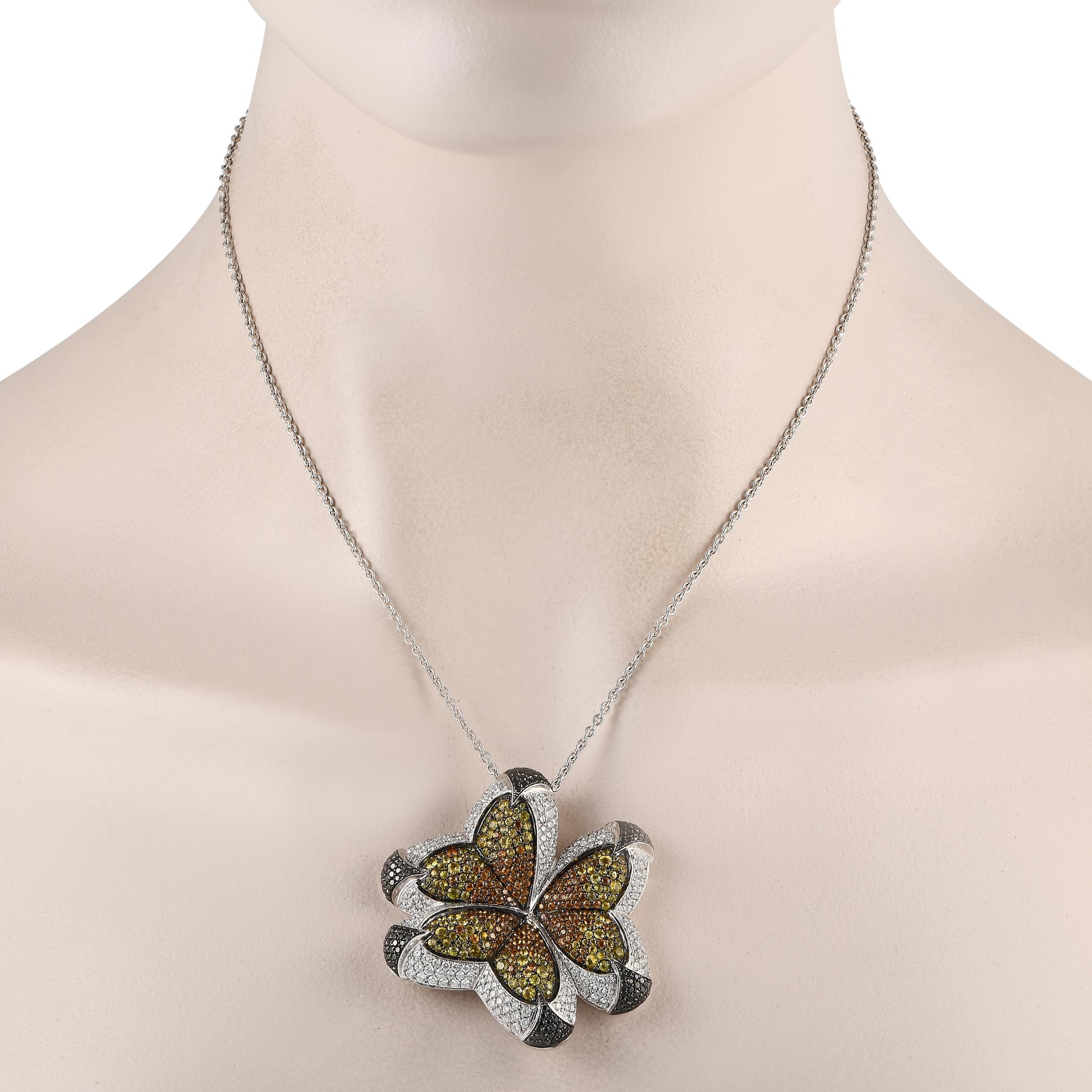 A cluster of butterflies boast the splendor of their glorious wings through multi-colored stones. 2.50ct white diamonds with compliments of 1.31ct black diamonds provide an intricate framework to the spread of 4.97ct multi-colored sapphires.