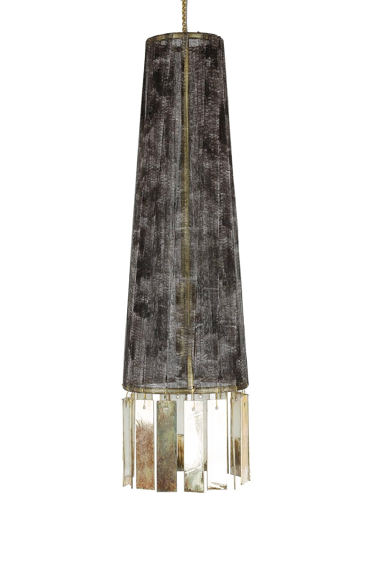 Magic is a hanging lamp entirely handmade and manufactured by hand, in Tuscany, Italy.
The lampshade body of this light object is in brass with mat finish.
The lampshade is wrapped with hand-painted cotton gauze strips, it is wrapped by hand