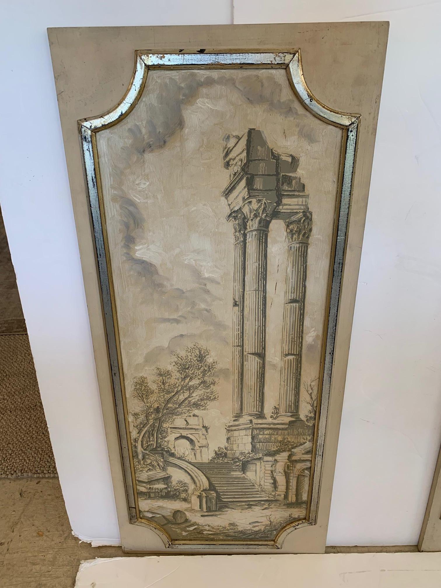 Set of four hand painted trompe l’oeil panels depicting four neoclassical architectural scenes with muted colors and framed in aged wood and silver gilt moldings. Measurements for each panel below.
 