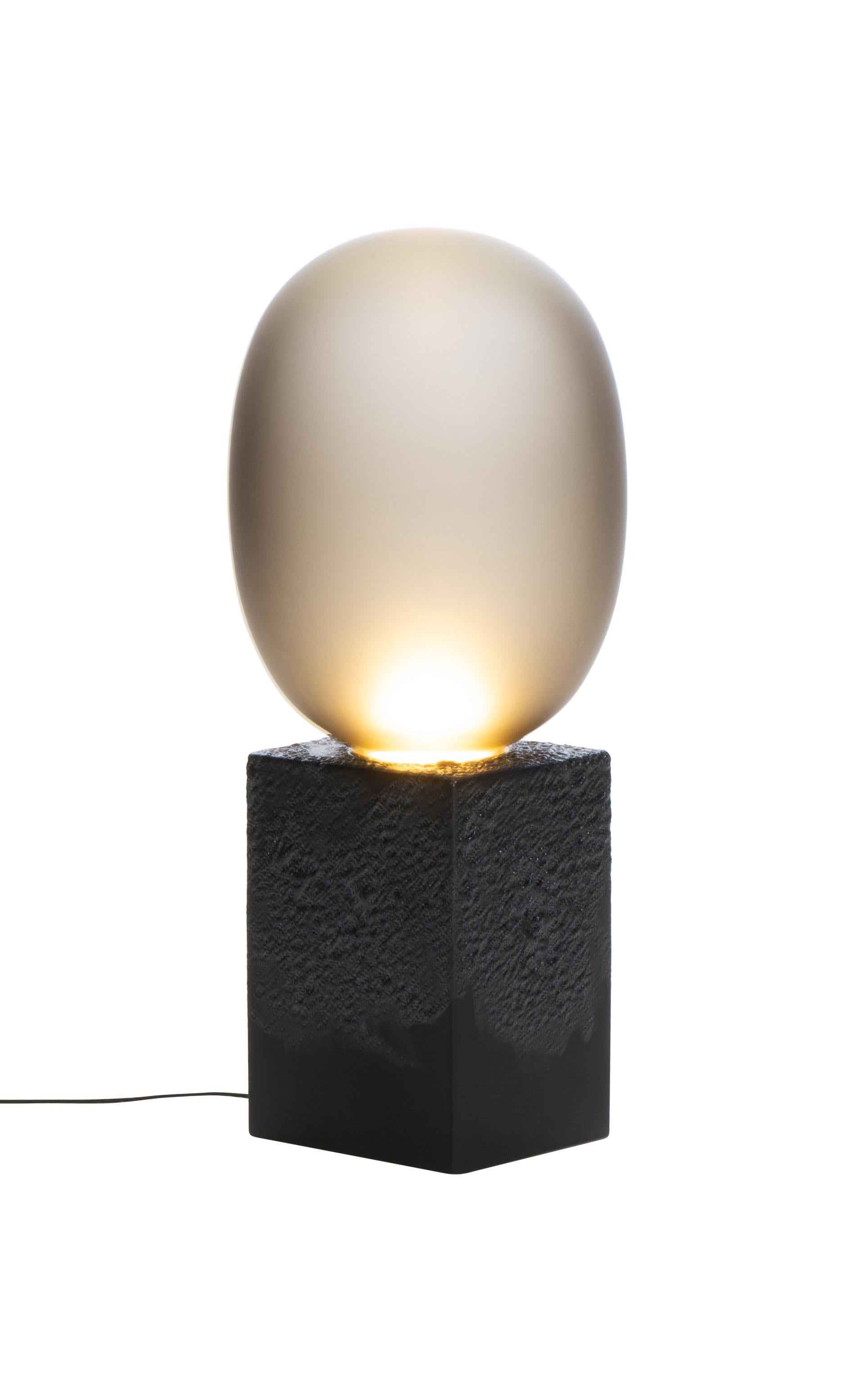 Magma One High Smoky Grey Acetato Black Table Lamp by Pulpo
Dimensions: D30 x W30 x H69 cm
Materials: Ceramic, handblown glass coloured, Textile

Also available in different finishes: smoky grey acetato black ,white acetato, black smoky grey