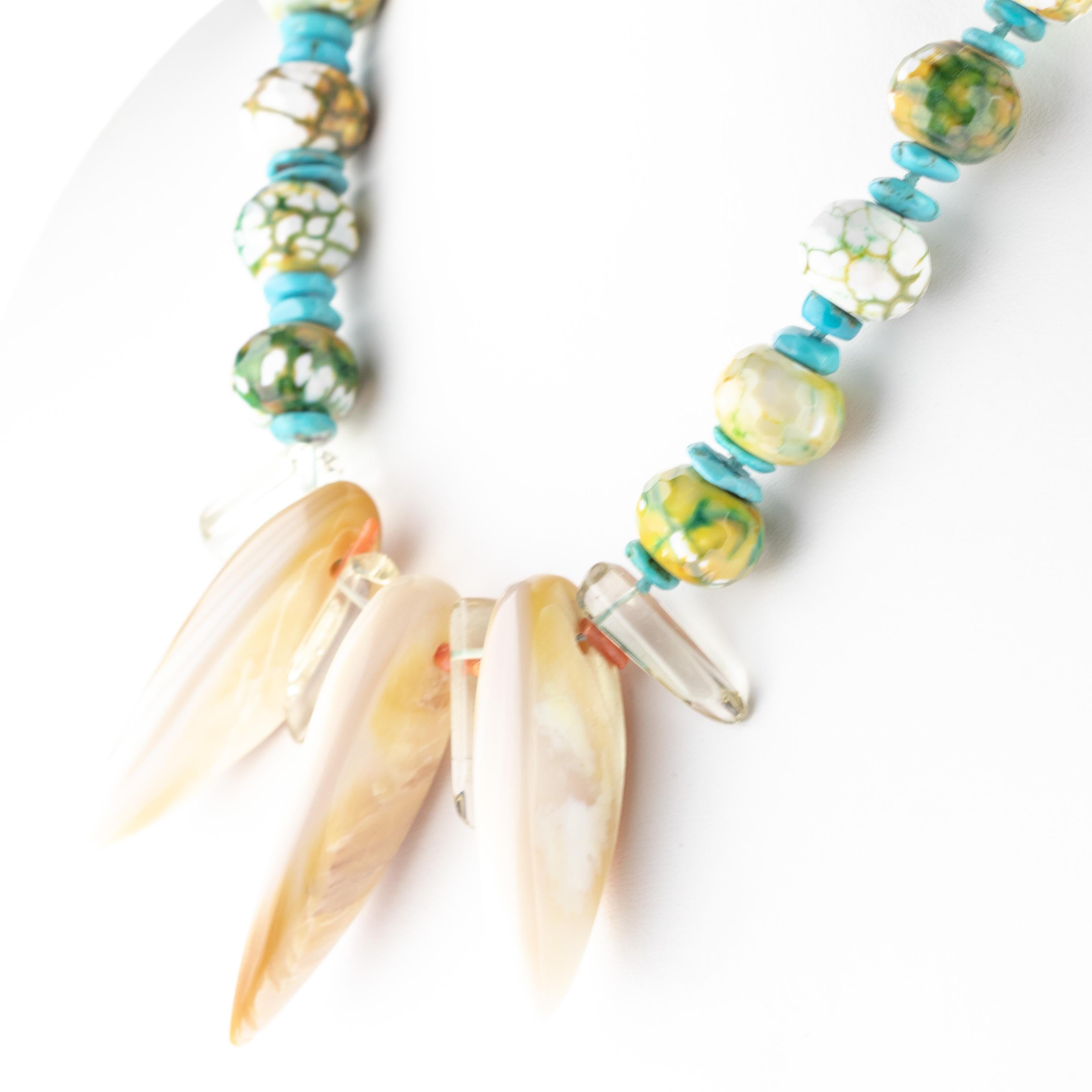 Charming jewellery piece full of color, savage shapes and textures. The magnesite and turquoise precious stones are softly intertwined with a rock crystal and mother of pearl rondelles. An exclusive and powerful combination that represents an