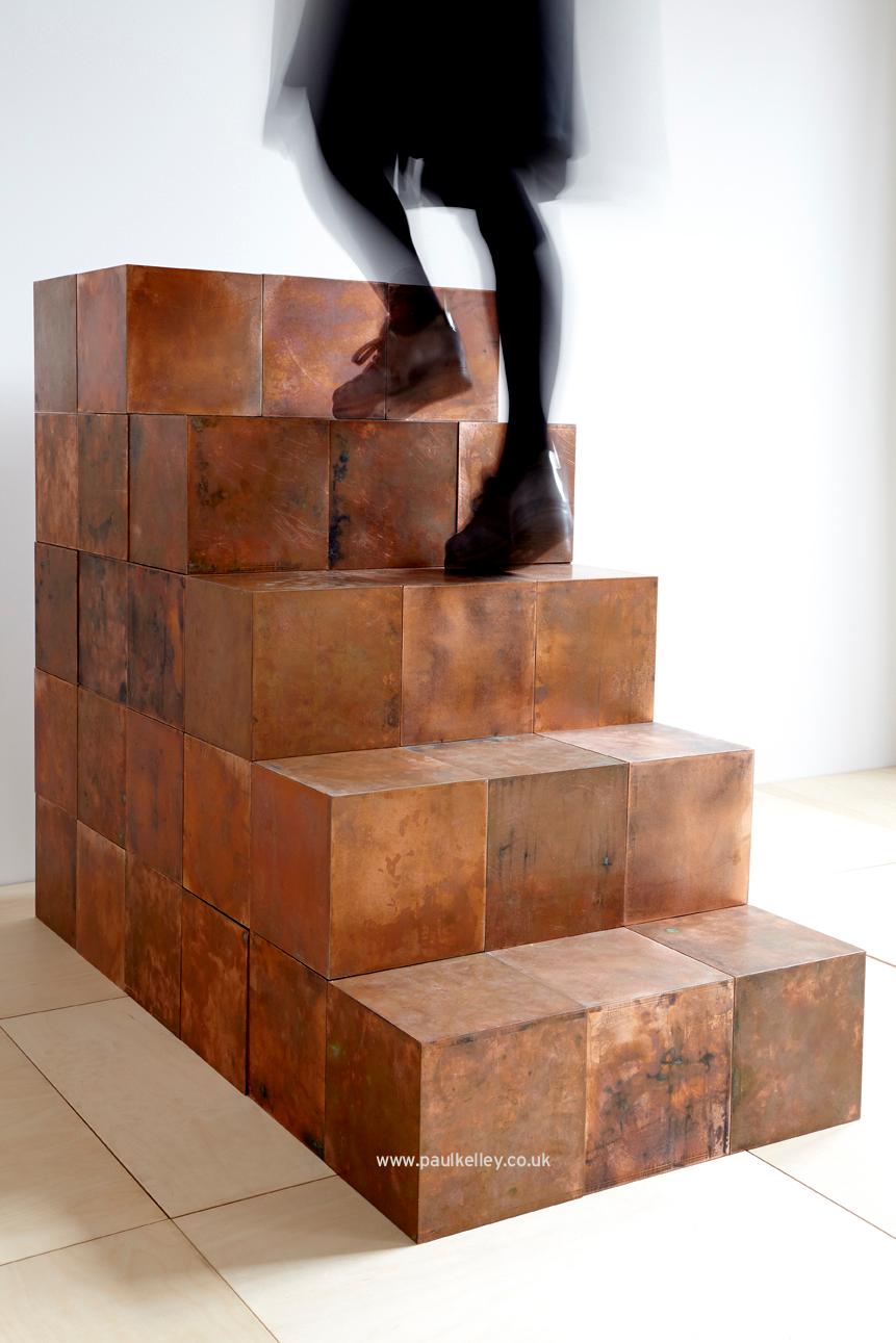 A magnetic system within the cubes allows them to be connected in any direction allowing the client to create their own designs. The copper comes preaged but over time the finish will change through sunlight, touch and use, thus making no two cubes