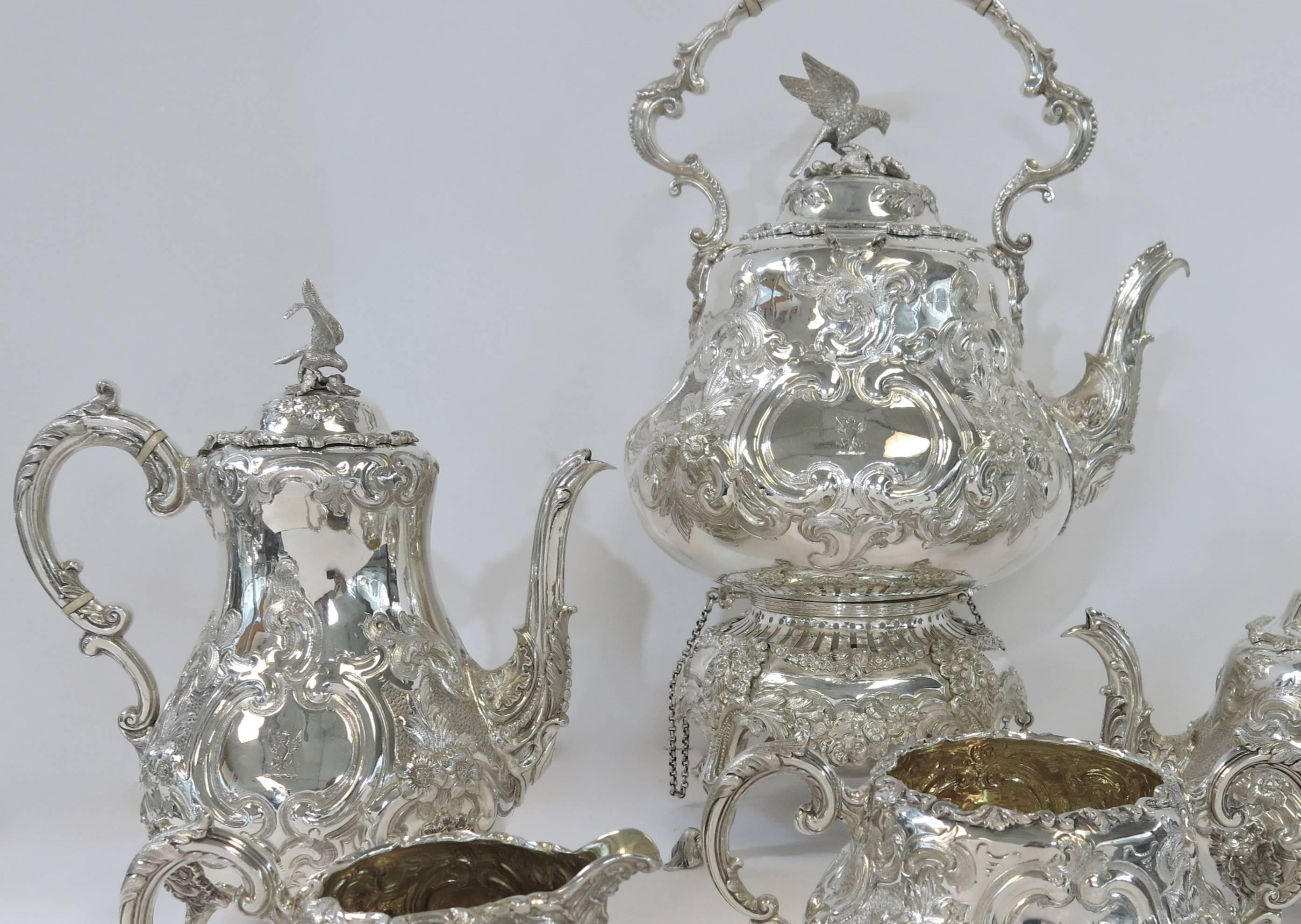 A superb quality, antique Victorian, hand chased sterling silver tea and coffee service, complete with the original tilting pot on stand with burner. The body is beautifully hand chased with floral decoration, and each piece stands on four cast and