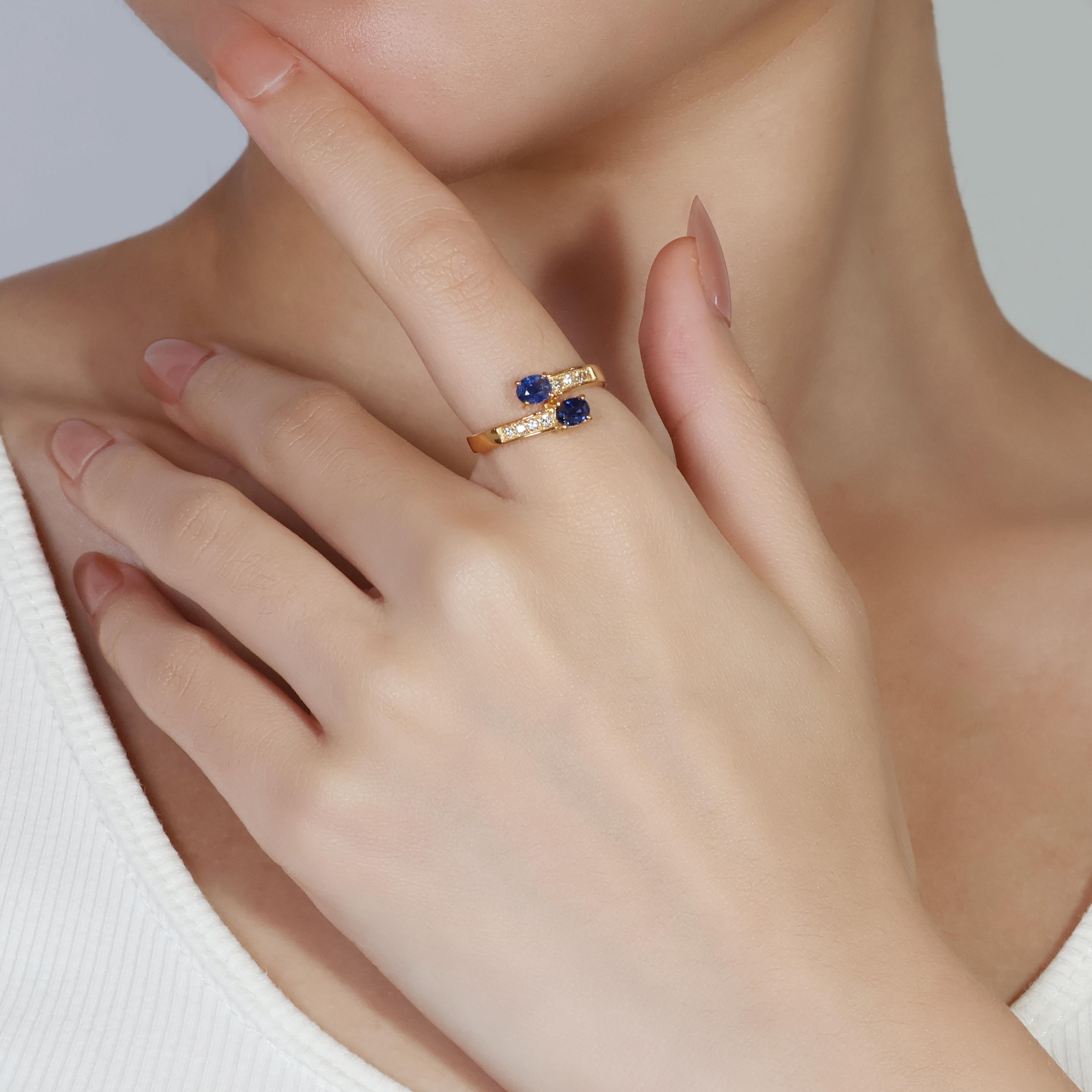 Presenting a stunning 20k yellow gold ring, showcases two captivating cushion-modified sapphires boasting a combined weight of 0.48 carats.  Complementing the sapphires are eight sparkling round brilliant cut diamonds totaling 0.12 carats, each