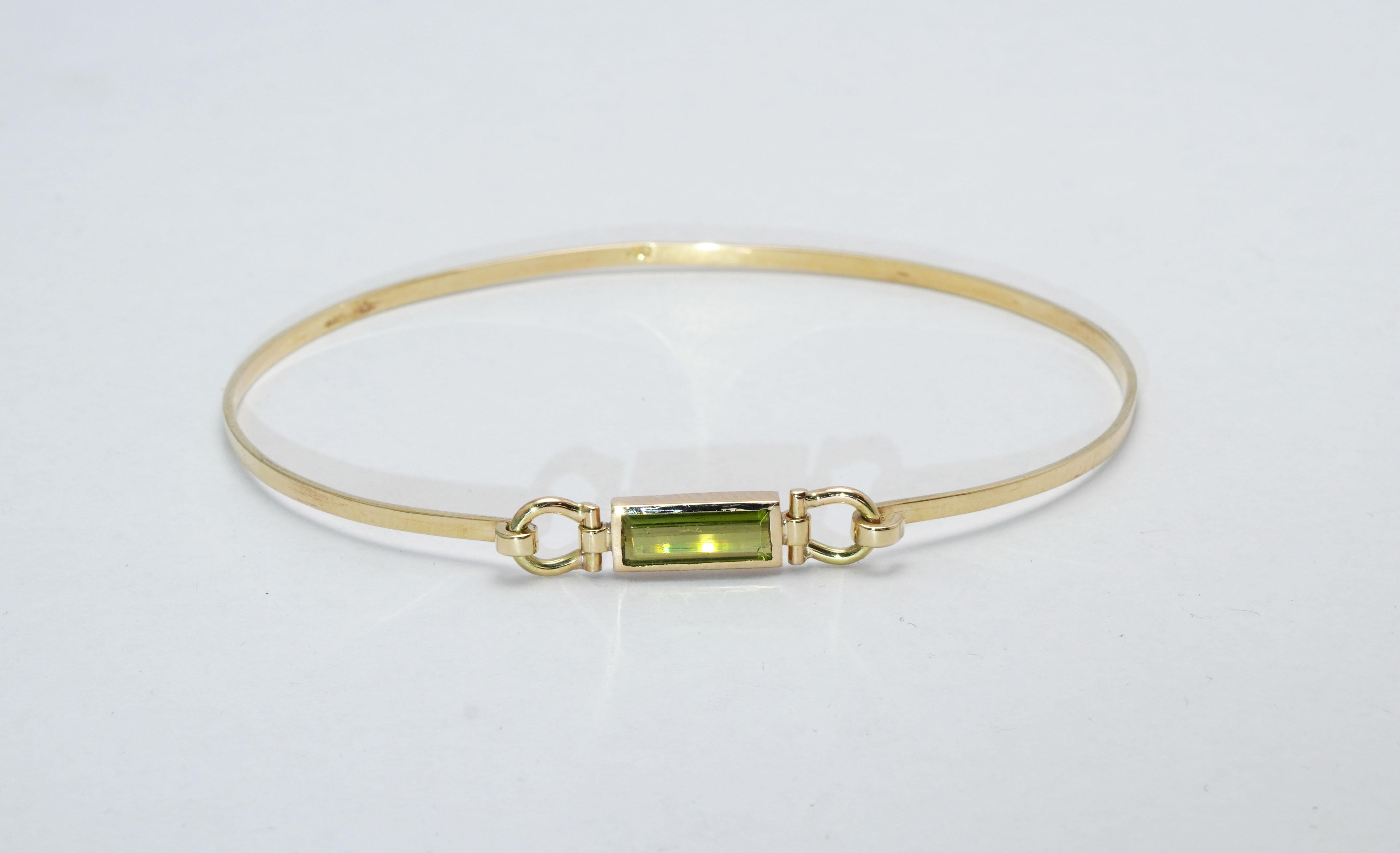 A magnificent handmade 14 ct. Yellow Gold Bracelet set with Green Tourmaline.
Gold color: Yellow
Dimensions: 62mm. x 52mm. 
Total weight: 4.27 grams 

Set with:
- Green Tourmaline
Cut: Baguette
Weight:  0.83 Carat
Color: Green